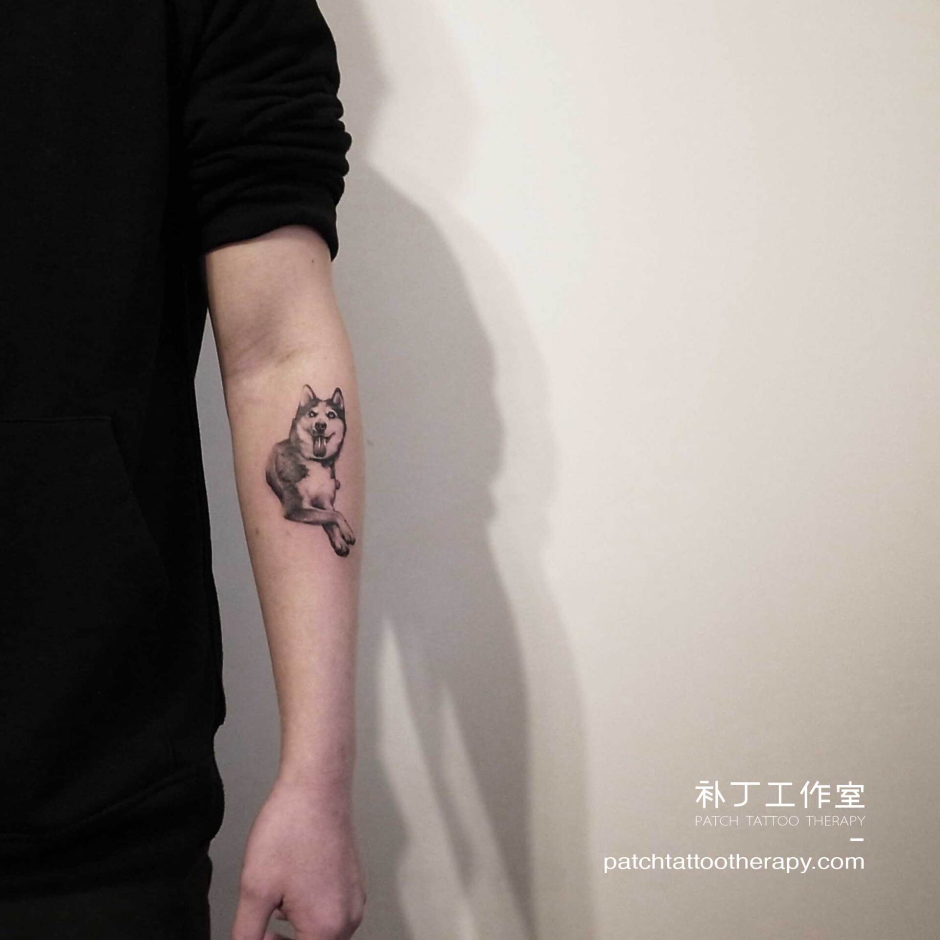 Inner forearm husky portrait tattoo in realistic black and white designed by Jingxi Gu at Patch Tattoo Therapy - angle 2