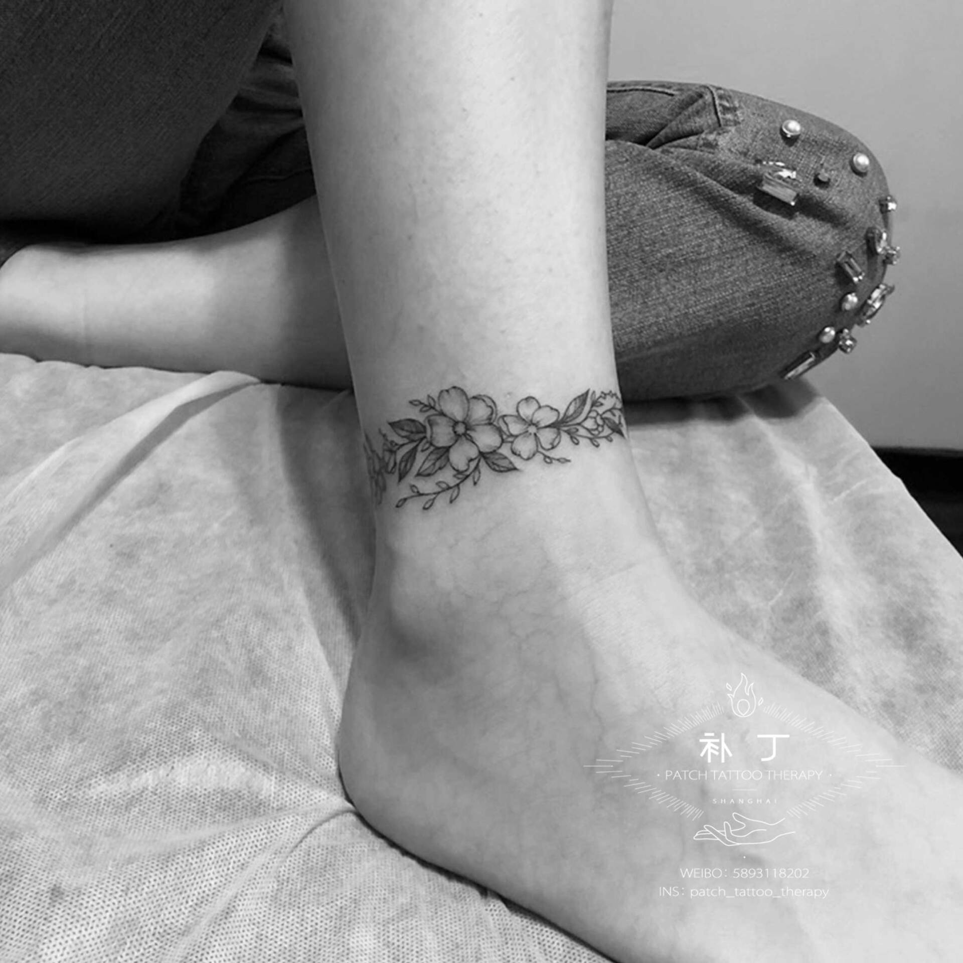Ankle tattoo of flowers designed by Jingxi Gu at Patch Tattoo Therapy