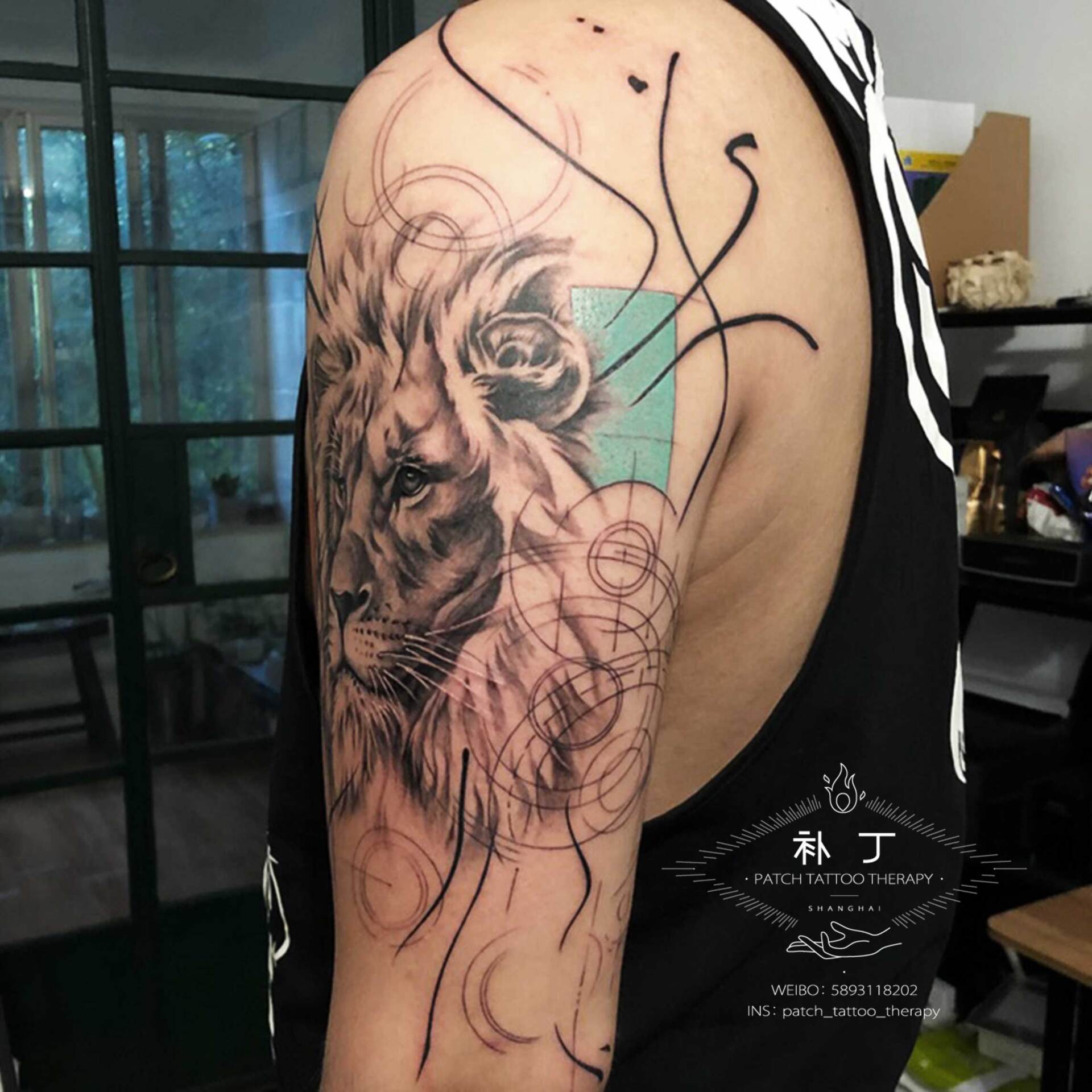 Outside arm tattoo of a Lion portrait with shapes in geometric style with some color designed by Jingxi Gu at Patch Tattoo Therapy - angle 3