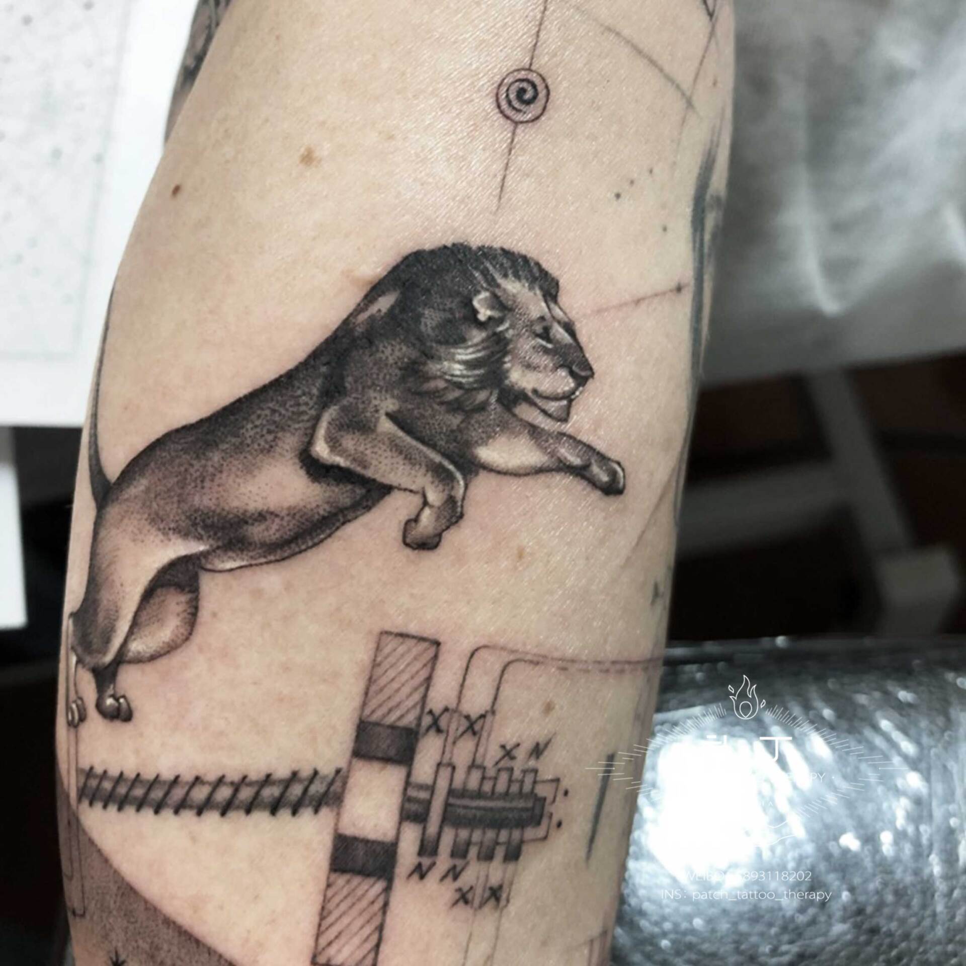 Full forearm sleeve tattoo featuring a space ship, a wife, planets, stars, a lion, an eye, nikota tesla elementes, and a satellite in geometric style designed by Jingxi Gu at Patch Tattoo Therapy - angle 6