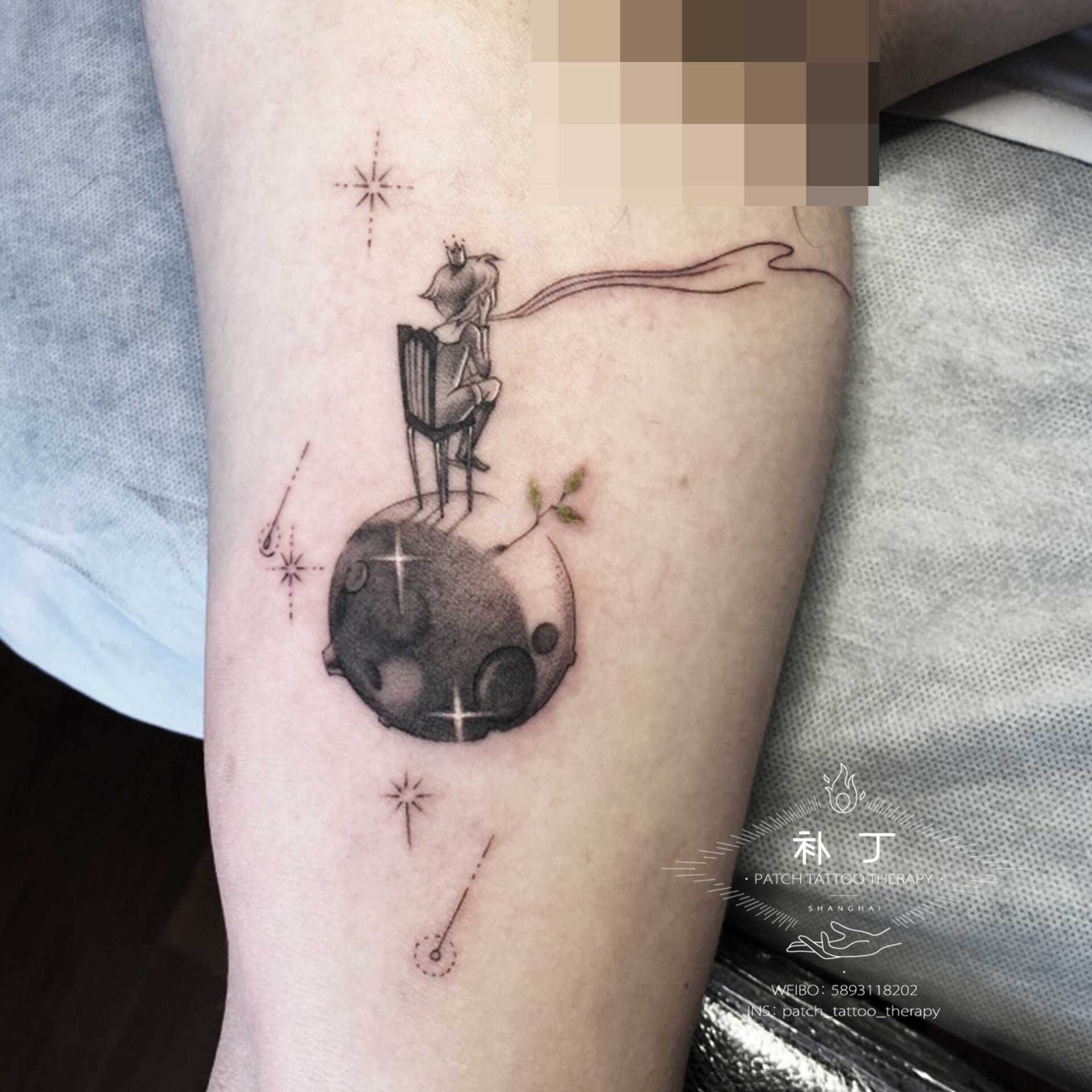 Inner arm tattoo of a Little Prince sitting on a planet overlooking the galaxy amongst stars in geometric style designed by Jingxi Gu at Patch Tattoo Therapy