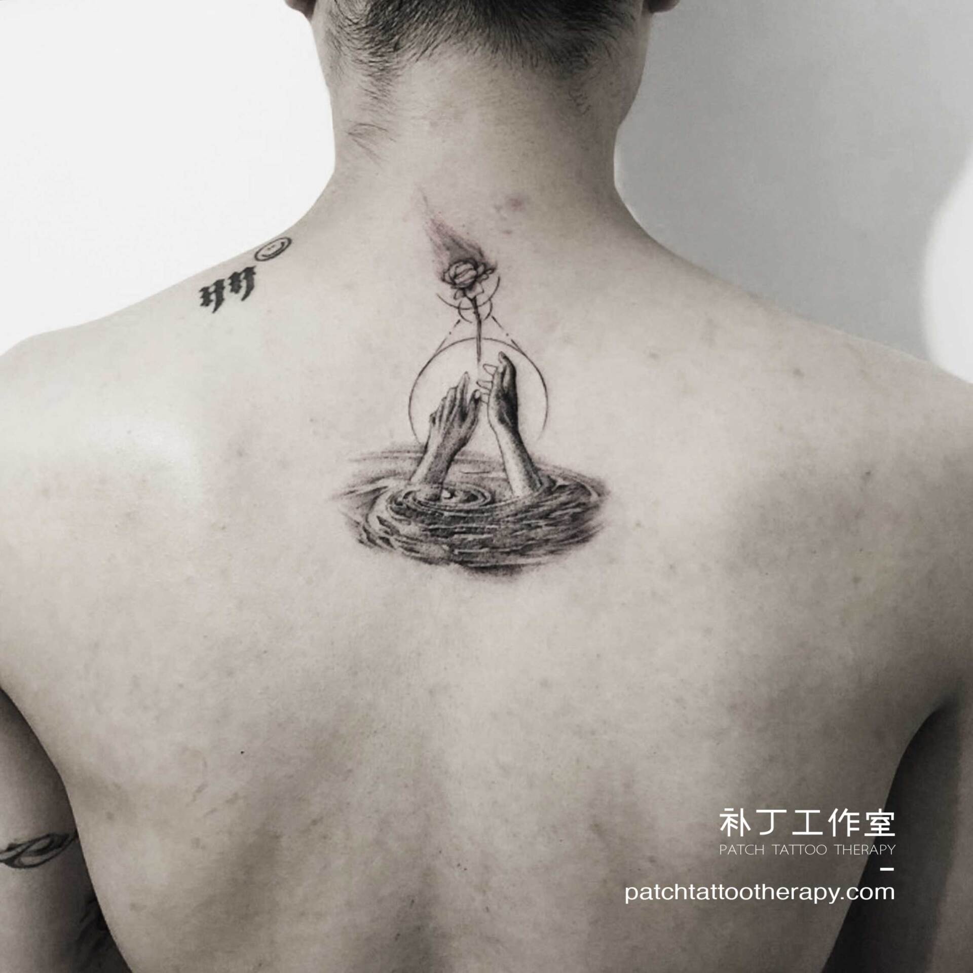 Back tattoo representing love out of control with two hands in water struggling to keep an escaping rose from leaving in geometric style designed by Jingxi Gu at Patch Tattoo Therapy - angle 1