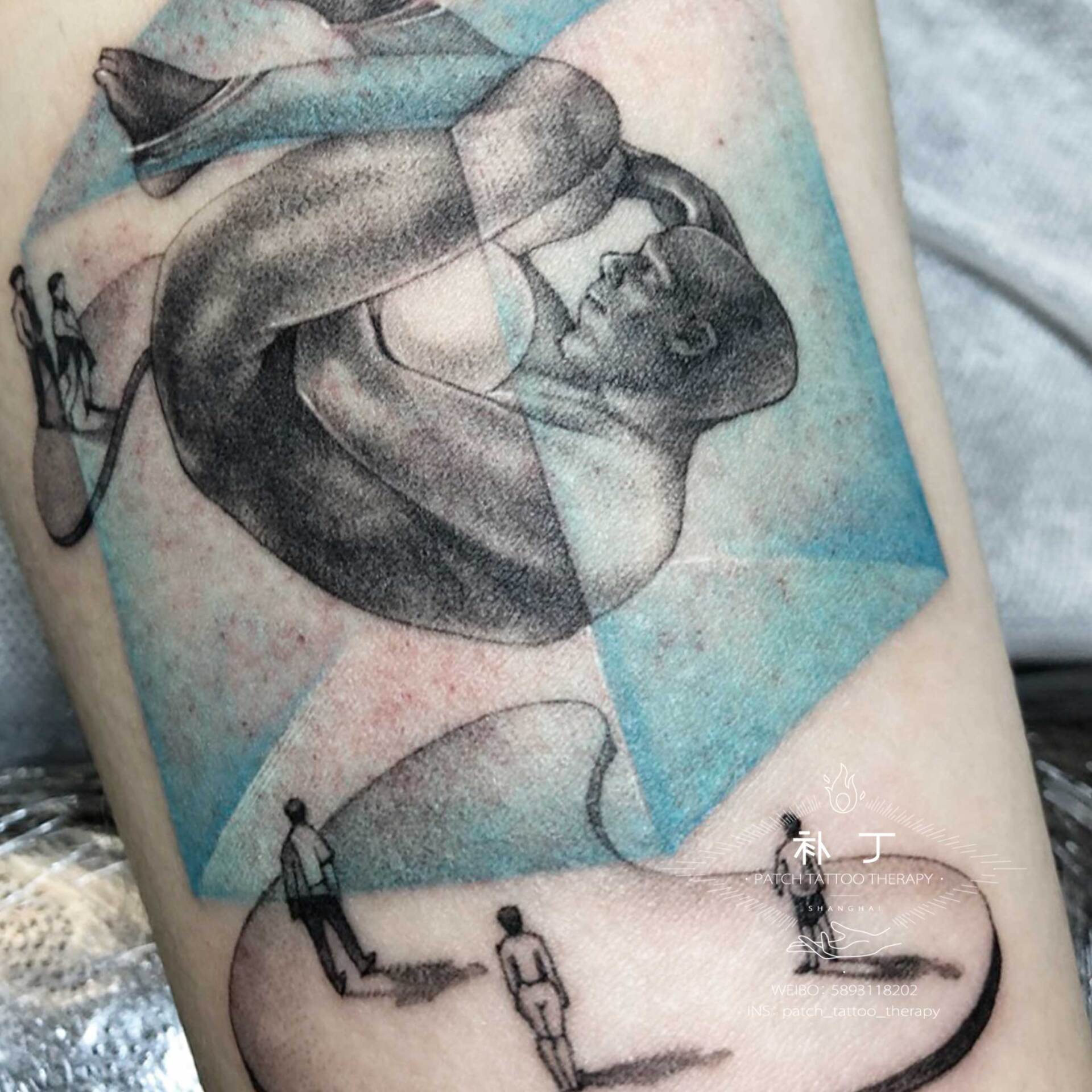 Inner arm tattoo of an abstract man in a box with spectators outside in micro mini color designed by Jingxi Gu at Patch Tattoo Therapy - angle 2