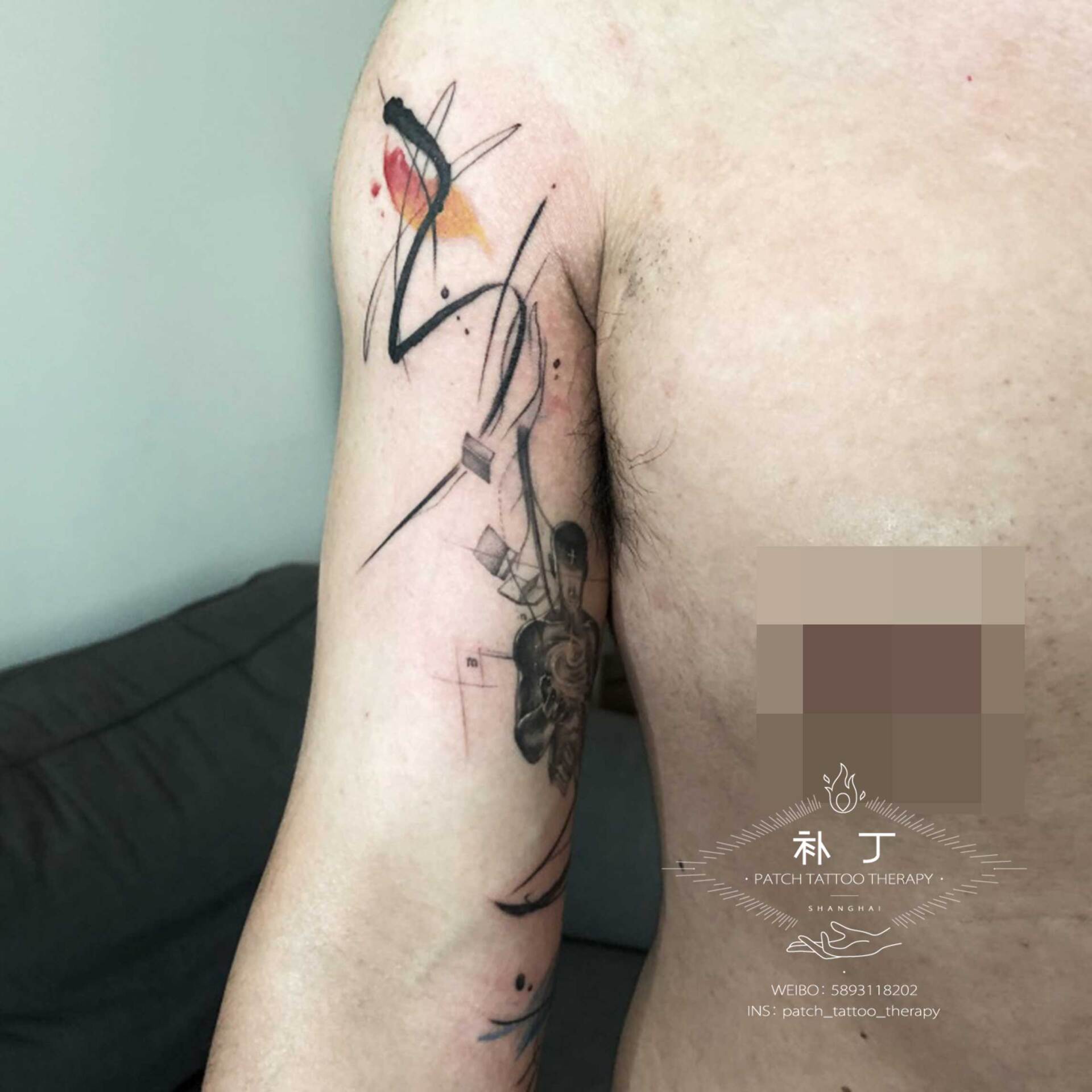 Arm tattoo of an astract universe man harnessing the power of books in a geometric watercolor hybrid style with some color designed by Jingxi Gu at Patch Tattoo Therapy - angle 2