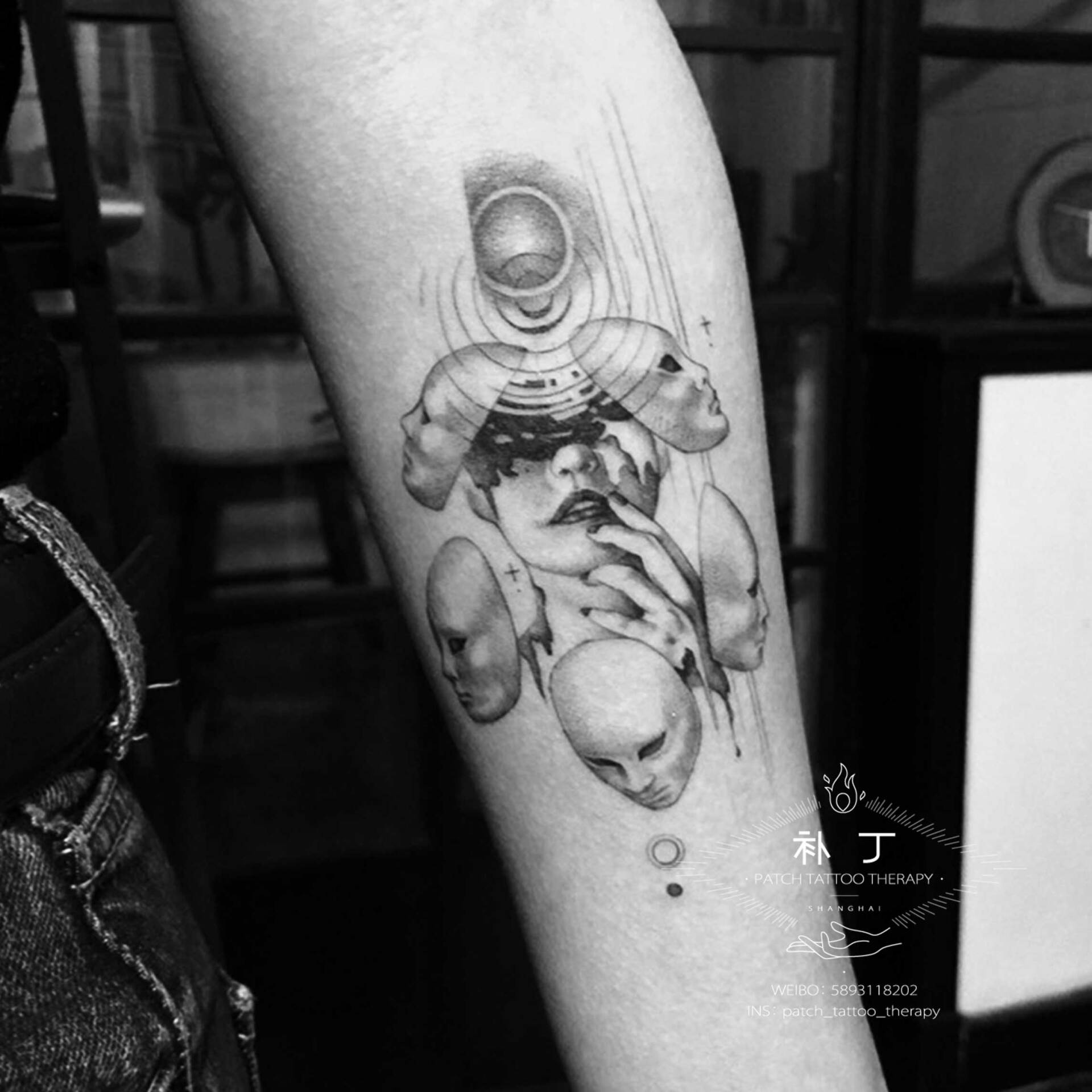 Inner forearm tattoo of a woman with many faces as masks in geometric style designed by Jingxi Gu at Patch Tattoo Therapy