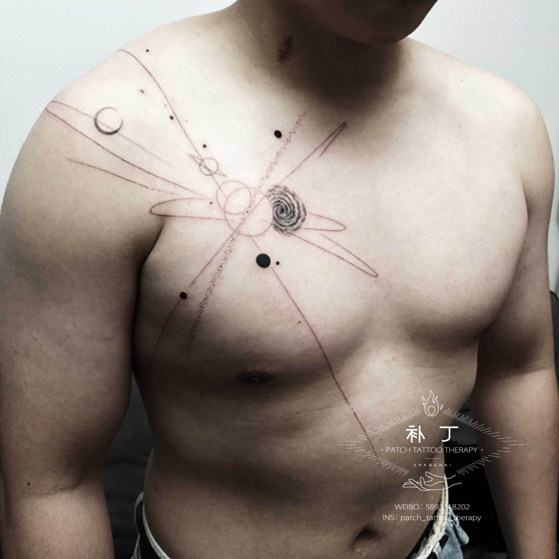Chest and shoulder tattoo of planets and the galaxy in geometric style designed by Jingxi Gu at Patch Tattoo Therapy