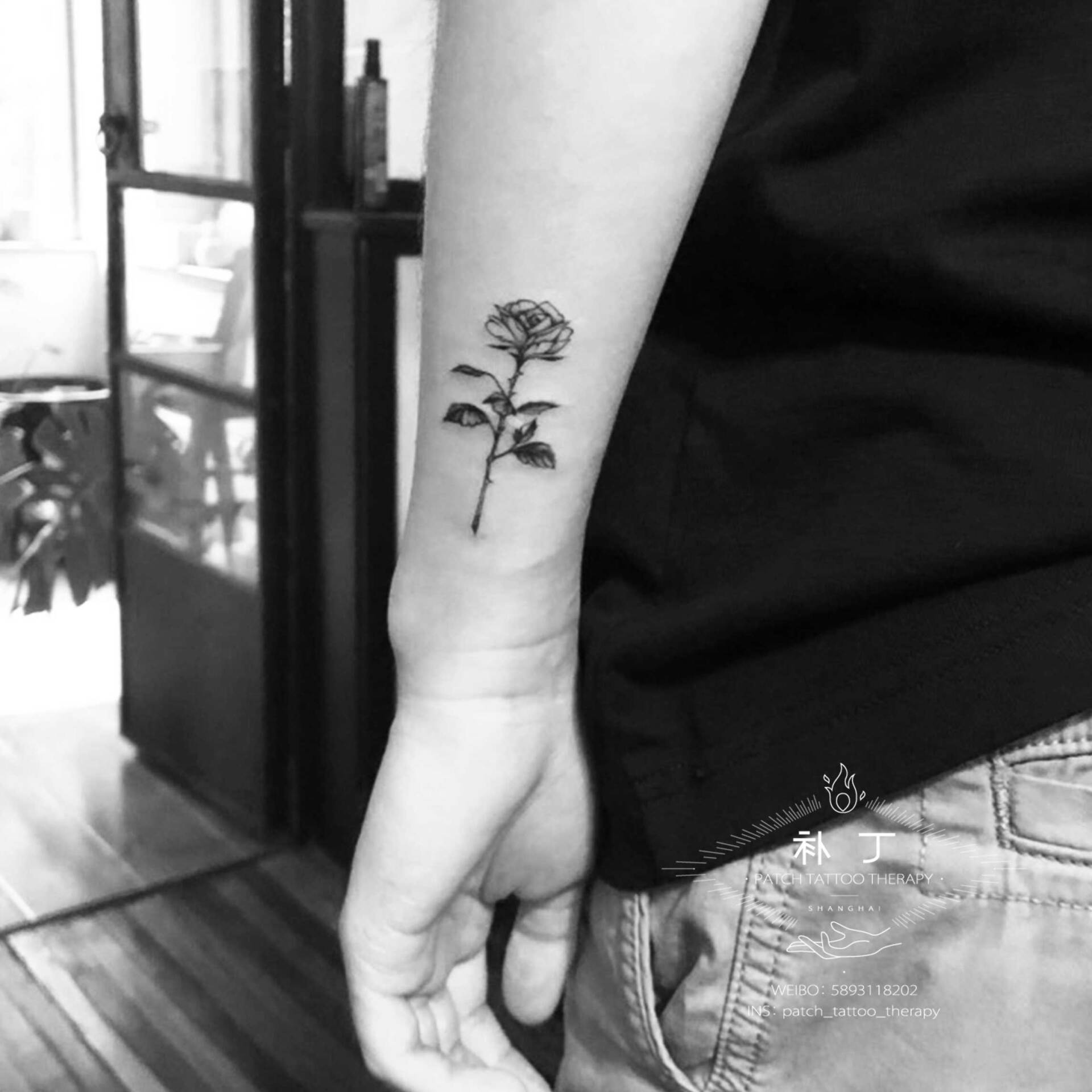 Outside forearm tattoo of a rose in micro mini stye designed by Jingxi Gu at Patch Tattoo Therapy