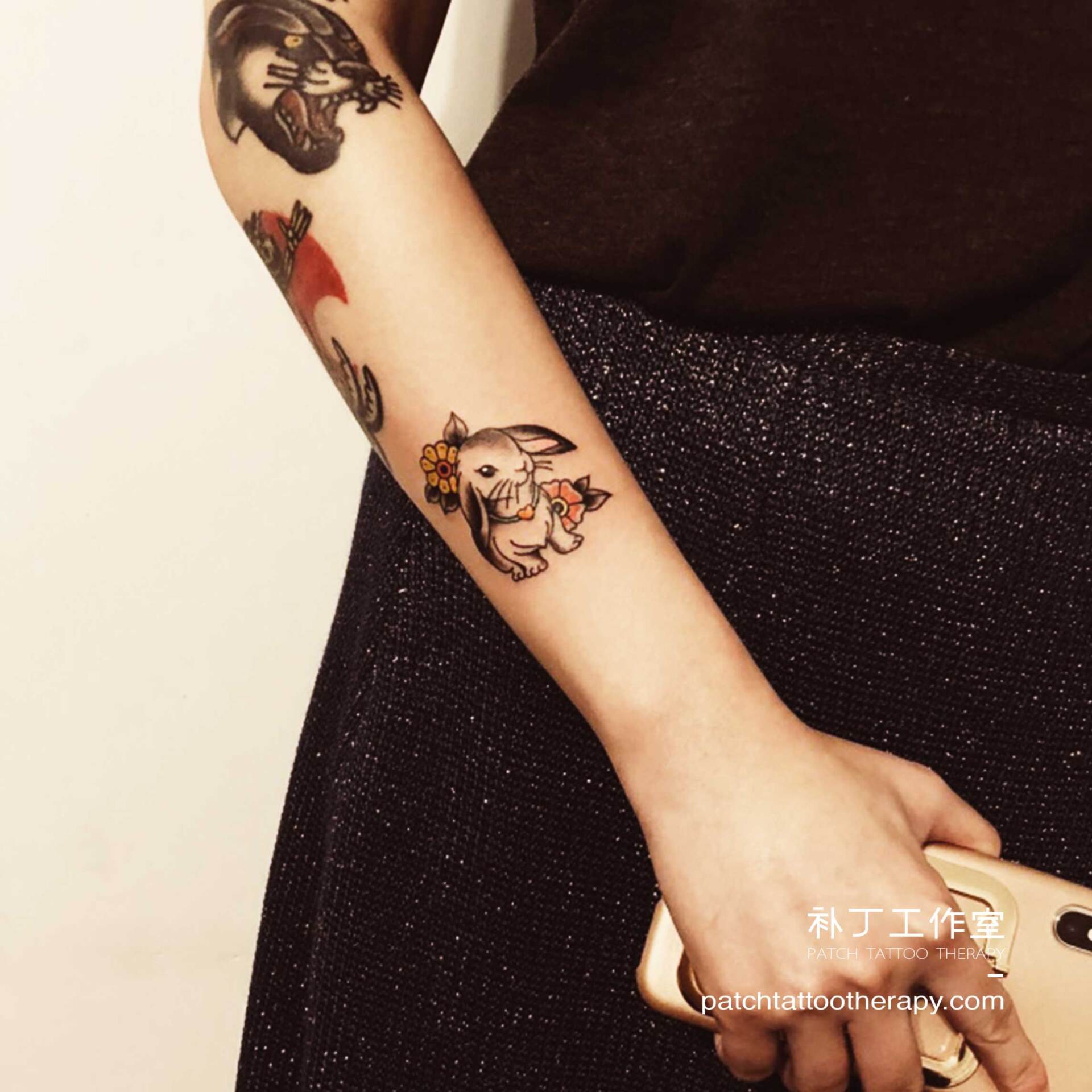 Outside forearm tattoo of a rabbit in traditional color designed by Jingxi Gu at Patch Tattoo Therapy