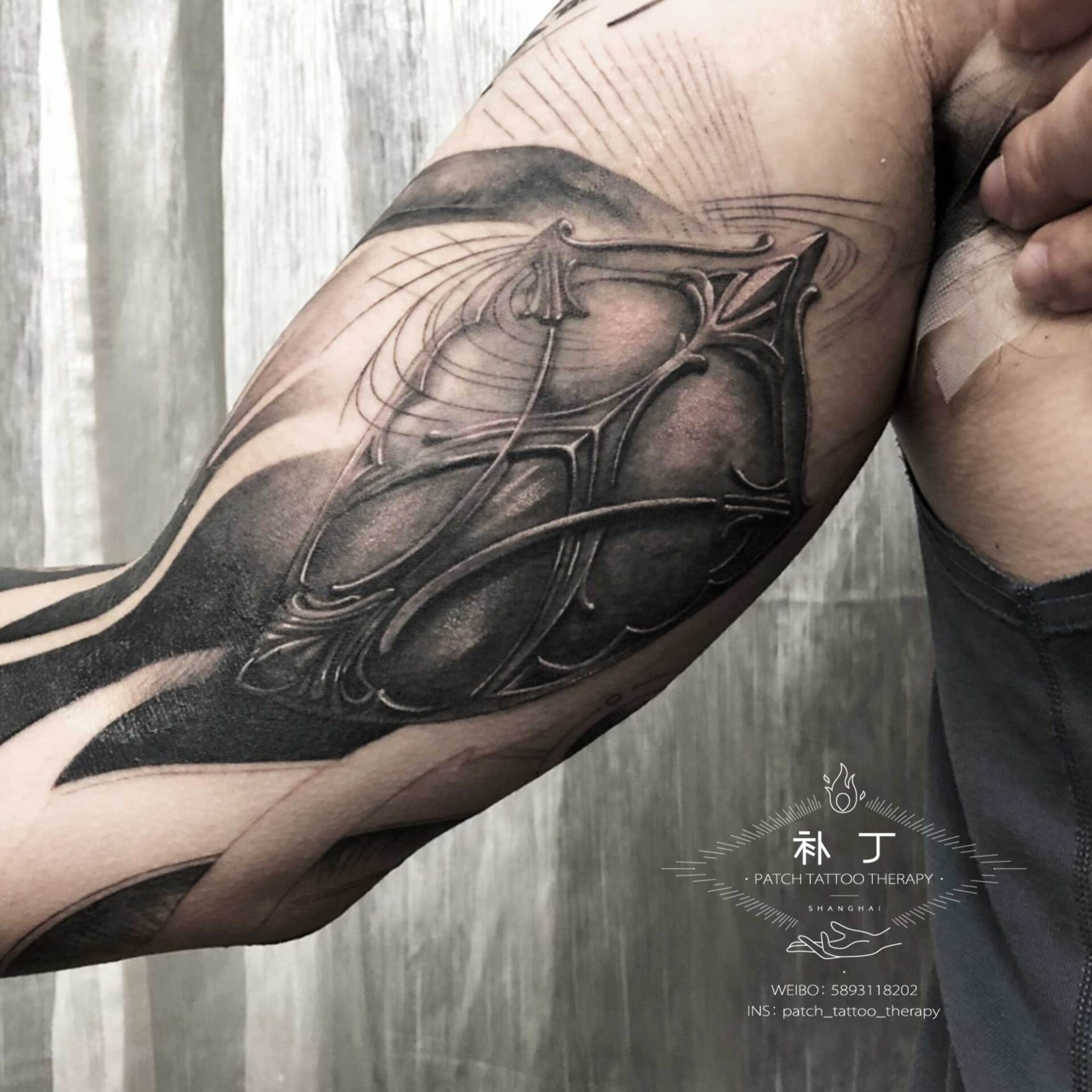 Full arm sleeve featuring a man fighting off meteors and comets with a lion portrait on the shoulder in black and grey realistic style designed by Jingxi Gu at Patch Tattoo Therapy - angle 5