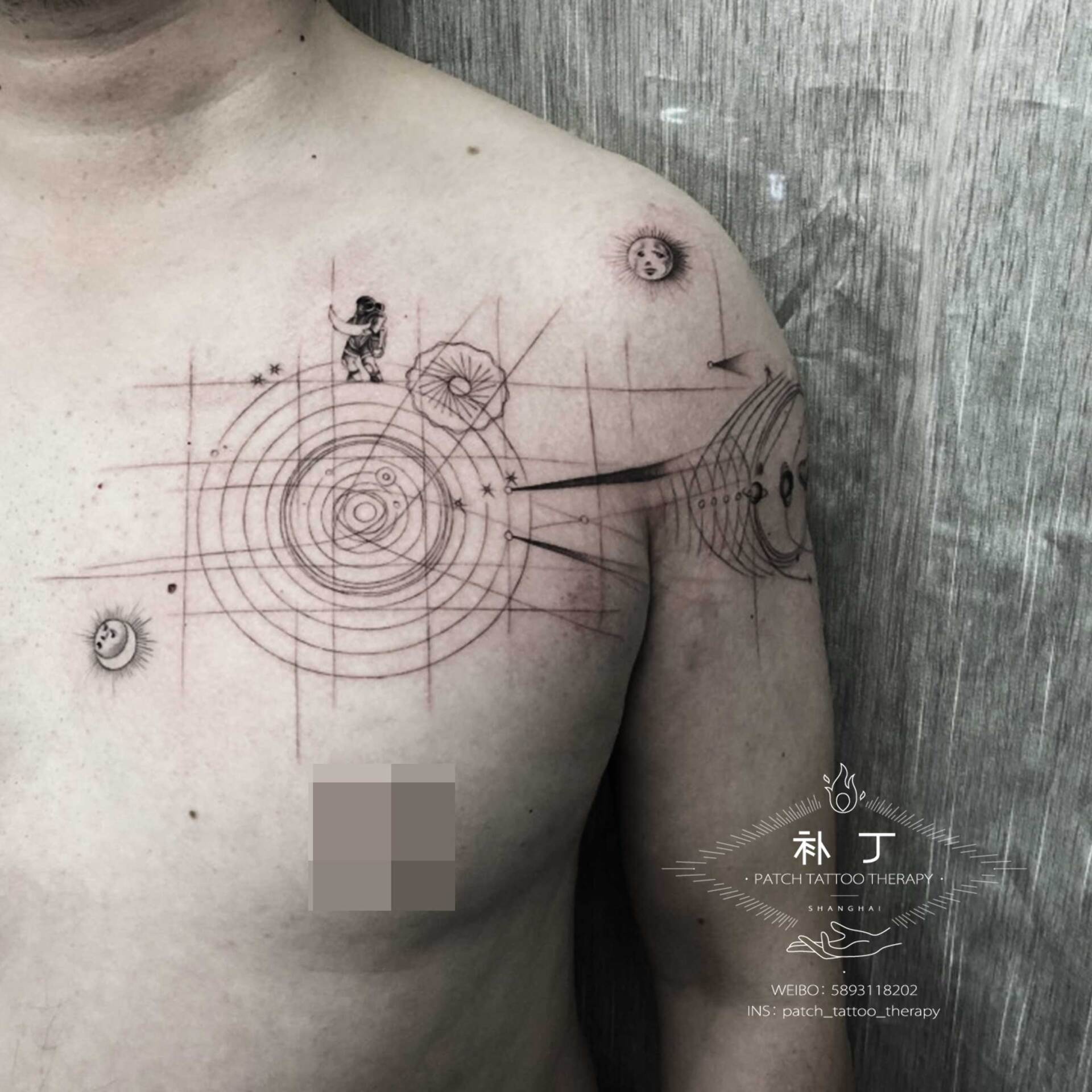 Shoulder and chest tattoo of a man holding a moon featuring the solar system, planets, the sun, and stars in geometric style designed by Jingxi Gu at Patch Tattoo Therapy - angle 4
