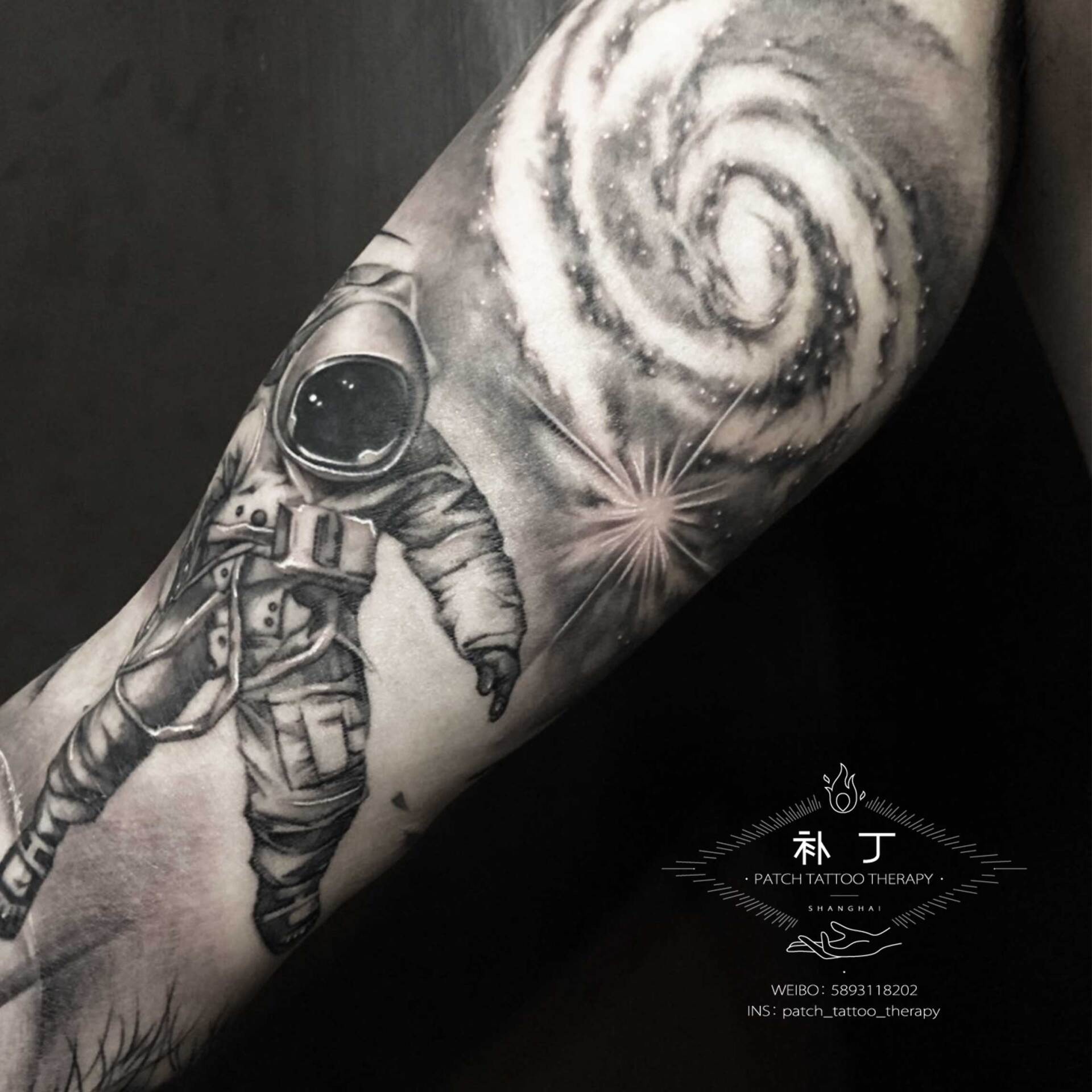 Full arm sleeve featuring a man fighting off meteors and comets with a lion portrait on the shoulder in black and grey realistic style designed by Jingxi Gu at Patch Tattoo Therapy - angle 3