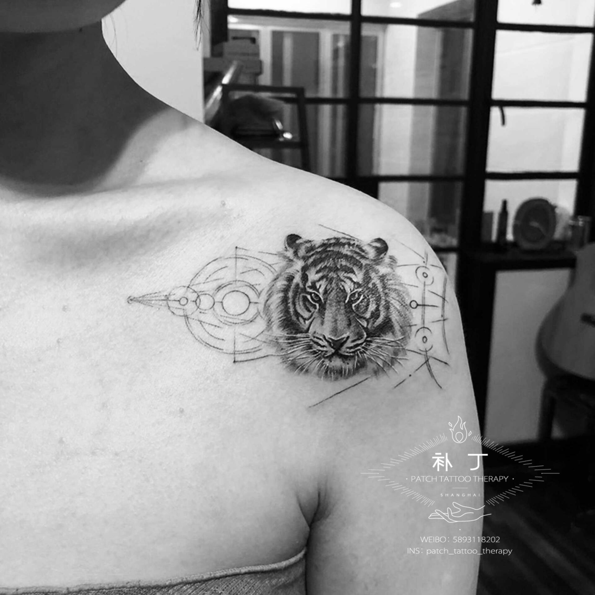 Shoulder blade tattoo of a tiger with shapes in geometric style designed by Jingxi Gu at Patch Tattoo Therapy