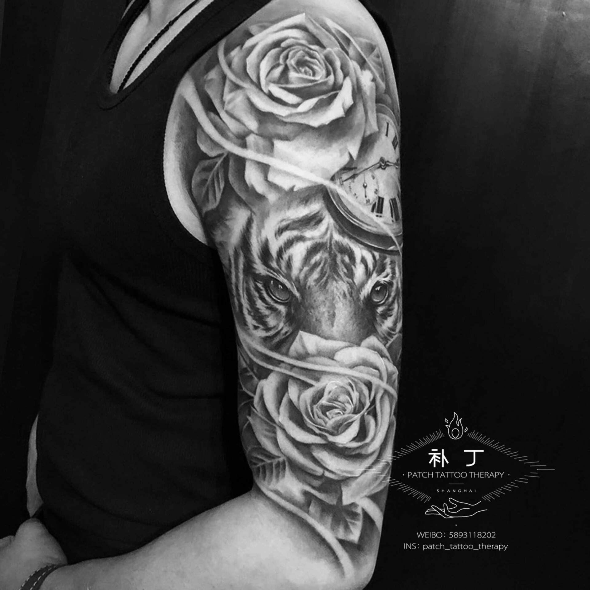 Half upper arm tattoo sleeve of a lion between two roses and a clock in black and grey realistic style designed by Jingxi Gu at Patch Tattoo Therapy - angle 2