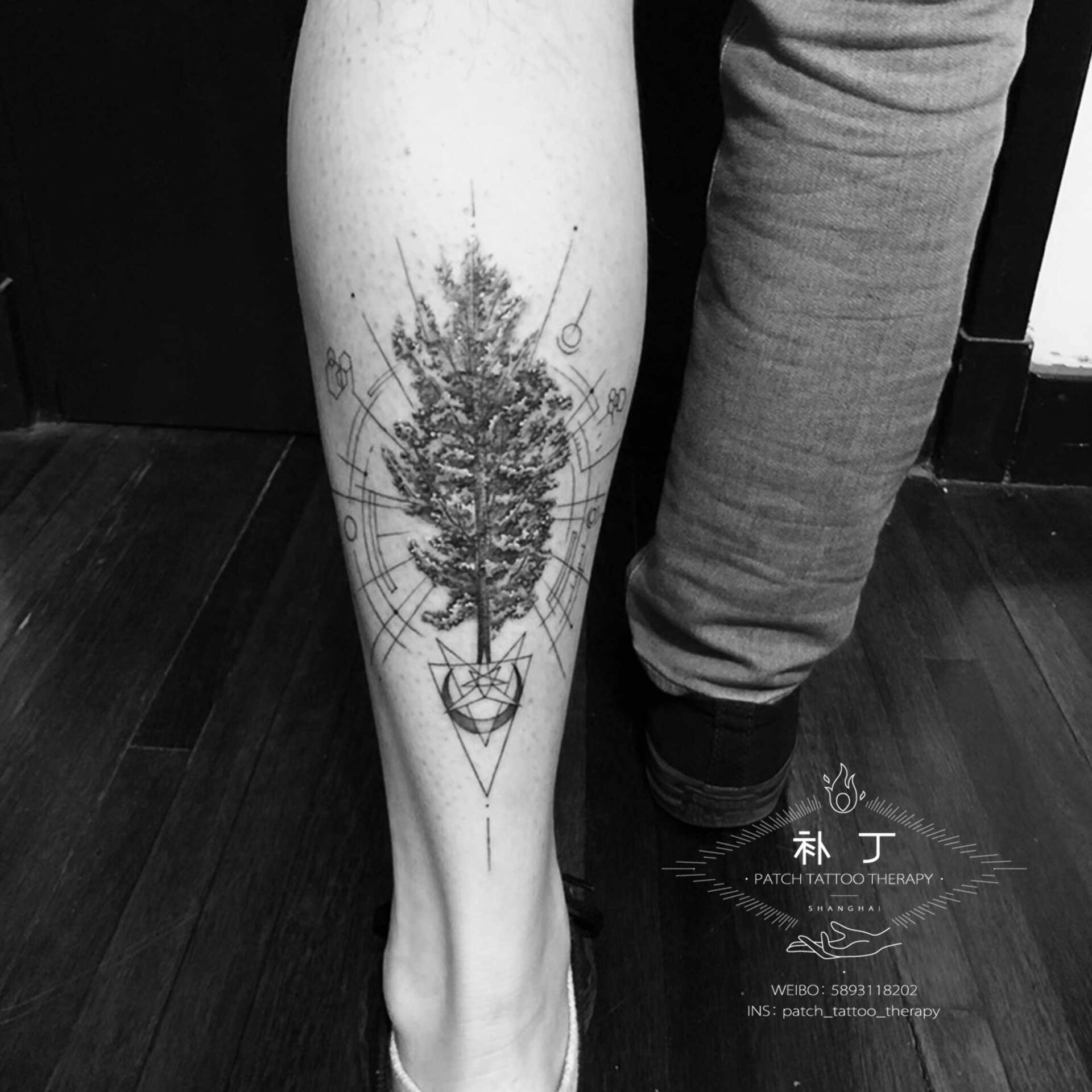 Outside calf  tattoo of a tree and other shapes in geometric style designed by Jingxi Gu at Patch Tattoo Therapy