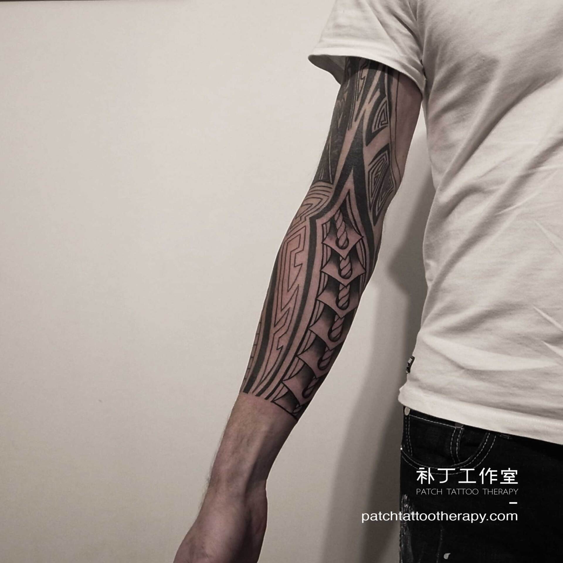 Full arm sleeve tattoo featuring a rope element in tribal style designed by Jingxi Gu at Patch Tattoo Therapy - angle 2