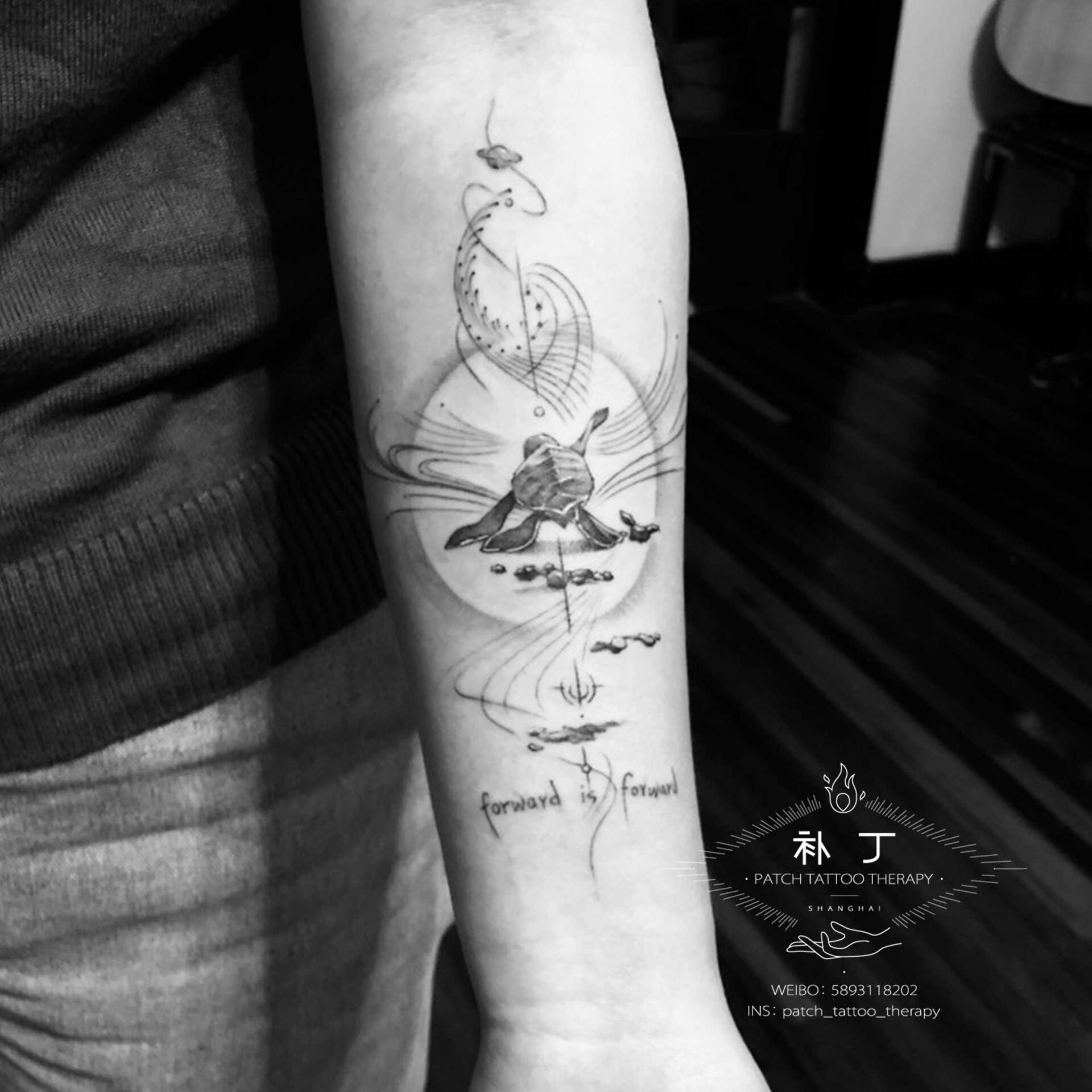 Inner forearm tattoo of a turtle crawling forward with text in geometric style designed by Jingxi Gu at Patch Tattoo Therapy