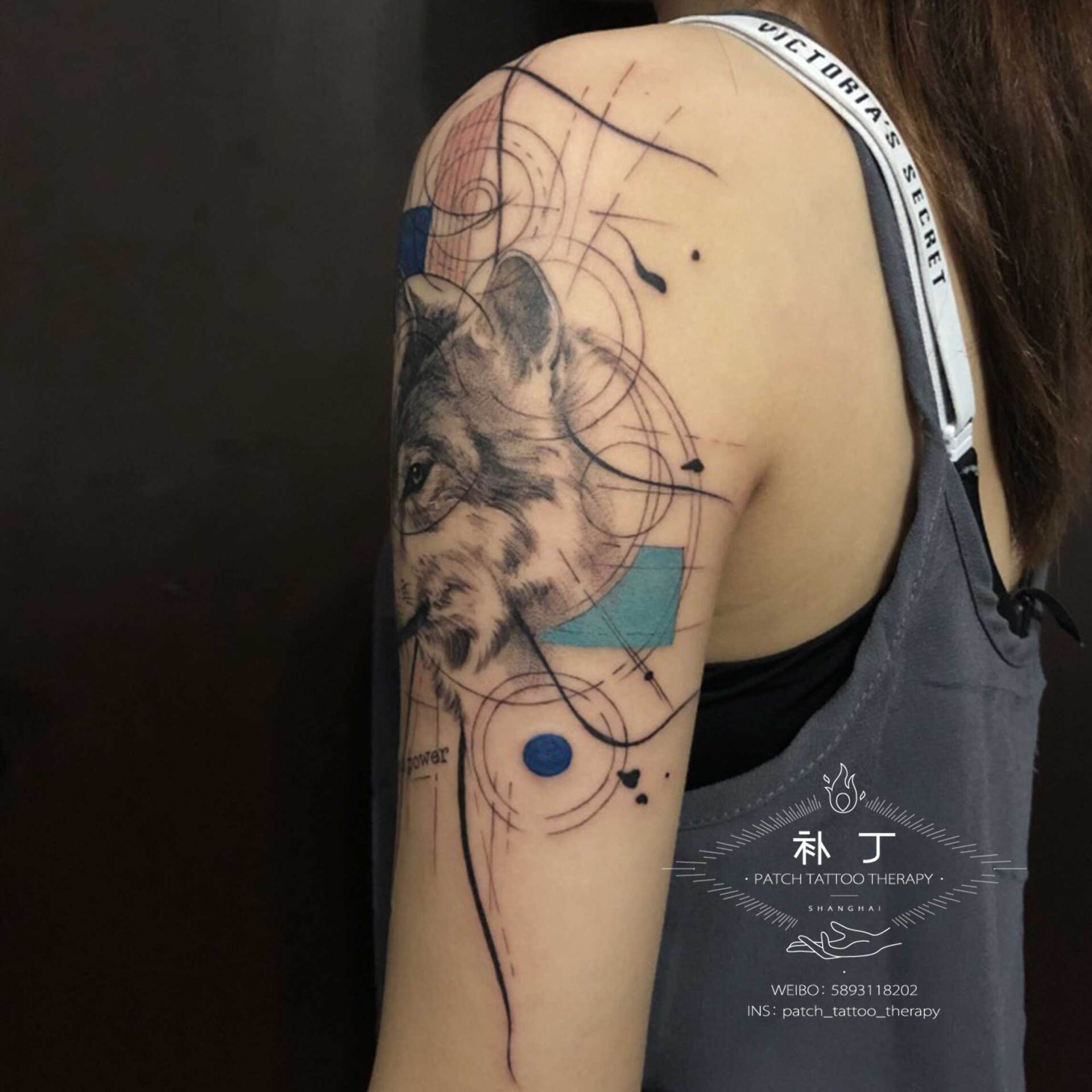 Outside arm tattoo of a Wolf portrait with shapes in geometric style with some color designed by Jingxi Gu at Patch Tattoo Therapy - angle 2