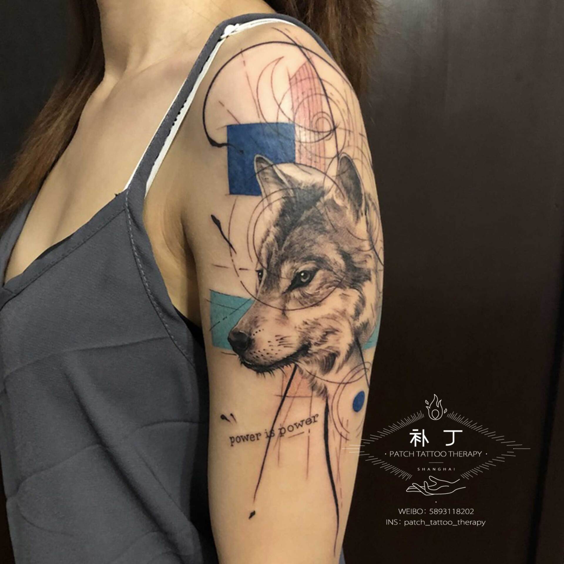 Outside arm tattoo of a Wolf portrait with shapes in geometric style with some color designed by Jingxi Gu at Patch Tattoo Therapy - angle 1