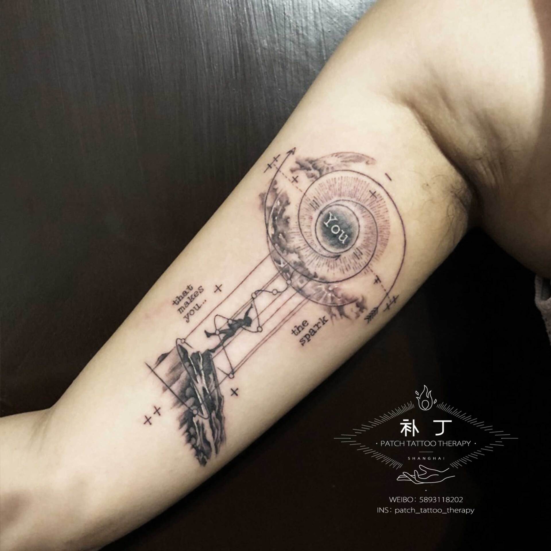 Inner arm tattoo of a small man walking up a cliff and an abstract eye above and small text in geometric style designed by Jingxi Gu at Patch Tattoo Therapy