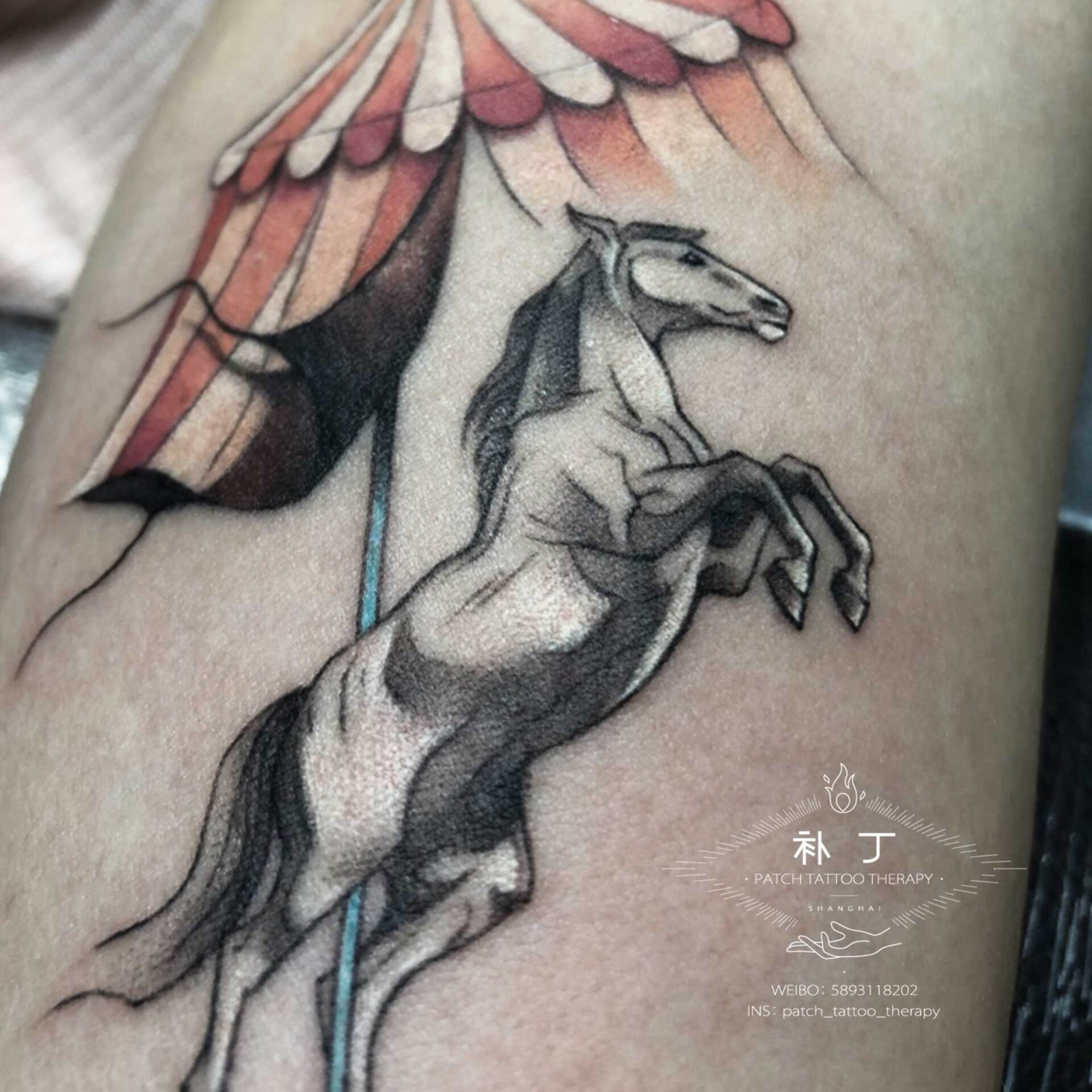 Inner arm tattoo of a carousel horse and balloons in micro mini color designed by Jingxi Gu at Patch Tattoo Therapy - angle 2