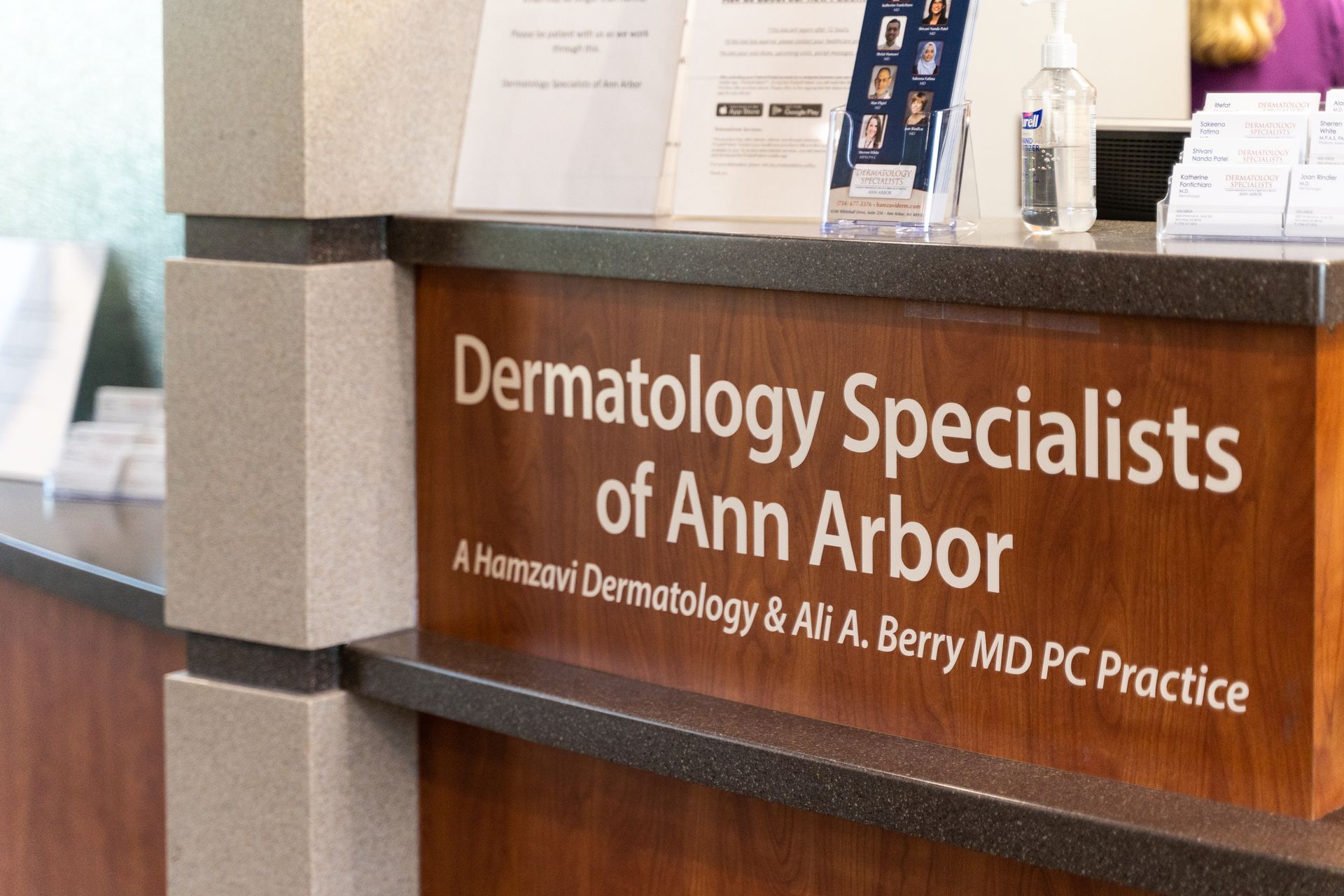 Sign for Dermatology Specialists of Ann Arbor at a reception desk.