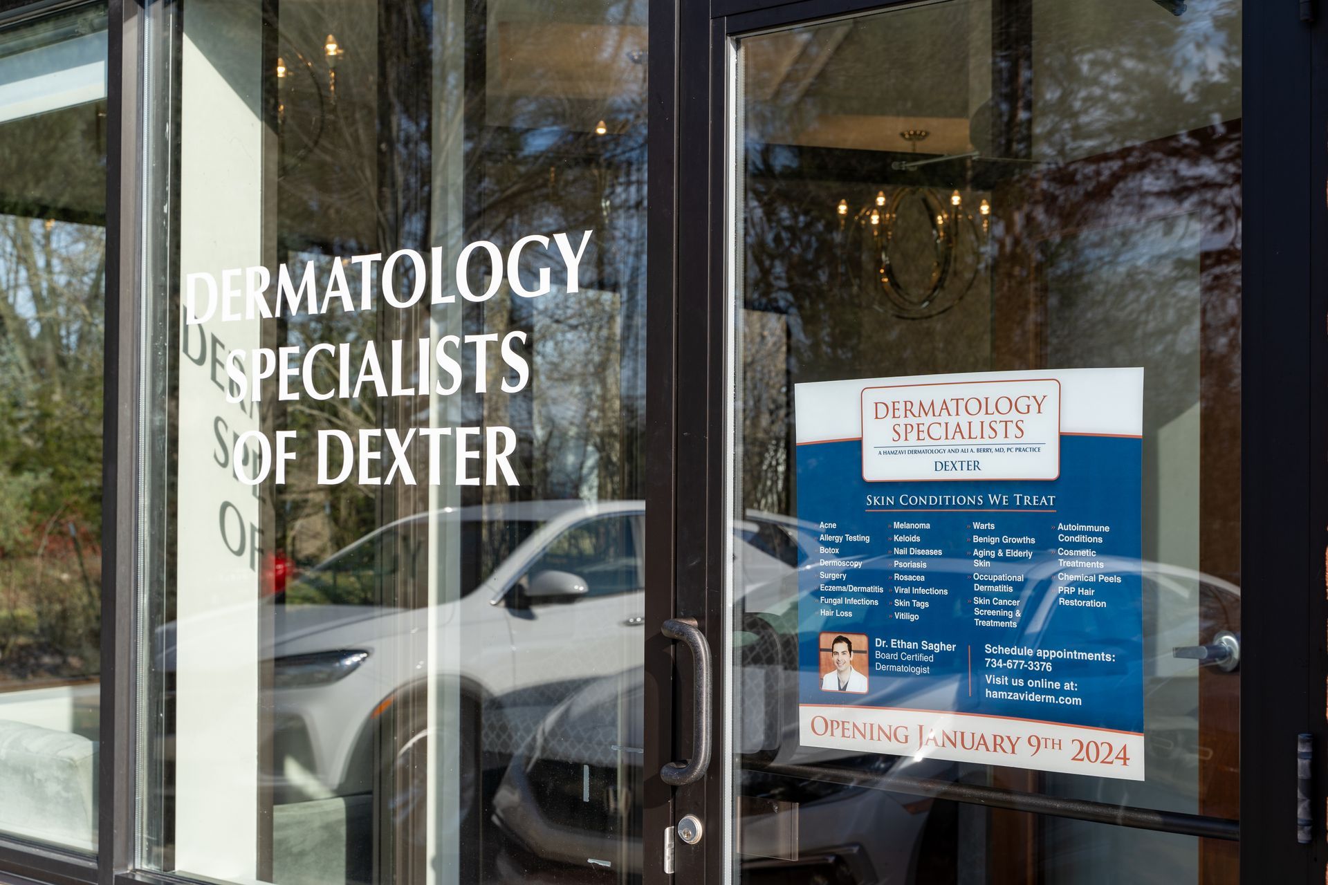 Dermatology Specialists of Dexter office exterior with signage, a car visible through the glass door.