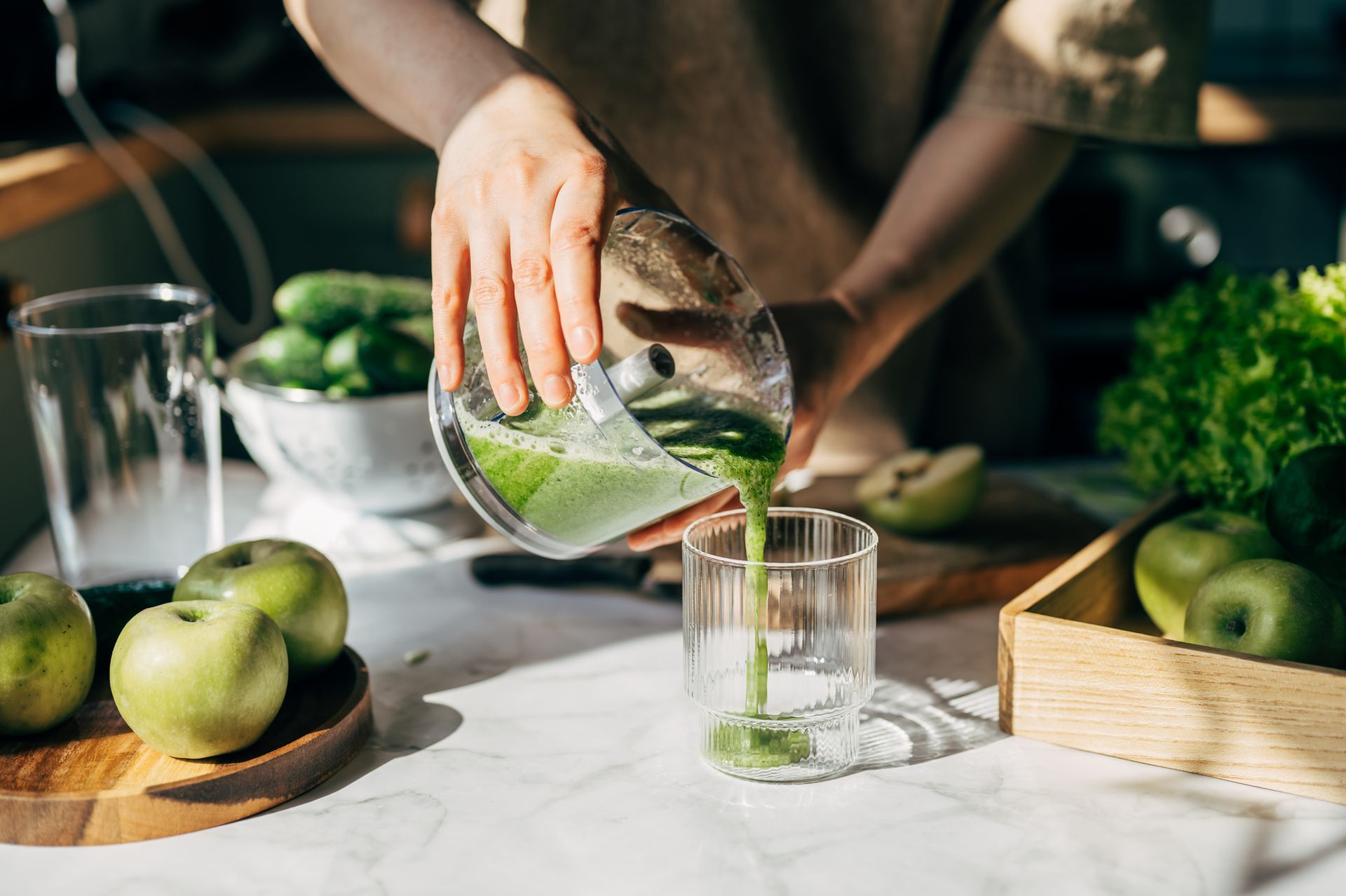 A young woman making a detox smoothie as part of her healthy routine for weight loss care at home