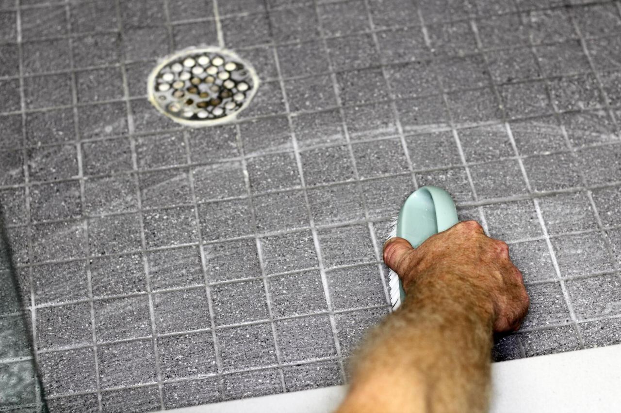 worker cleaning the floor tile