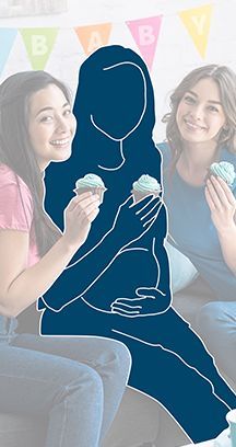 Two women and a pregnant woman in silhouette celebrating with cupcakes at a baby shower.