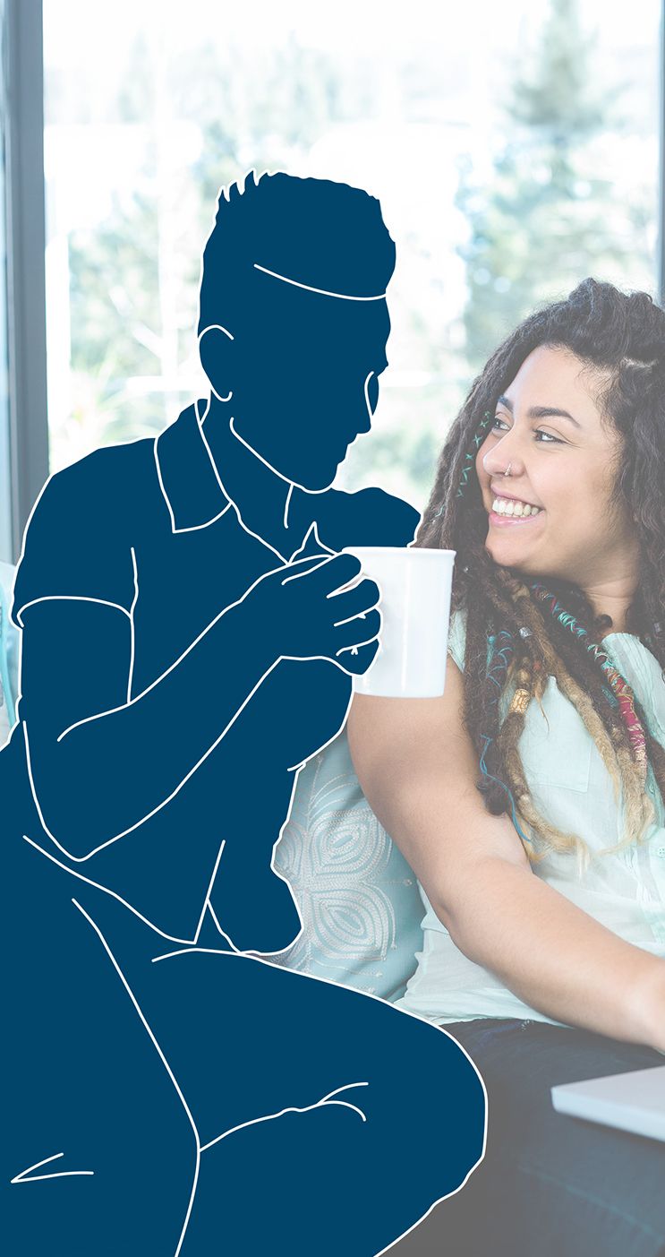Woman smiling at person in blue silhouette holding mug; sitting on a sofa near window.