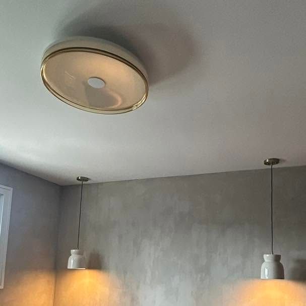 Minimalist gray room with a ceiling light and two hanging pendant lights