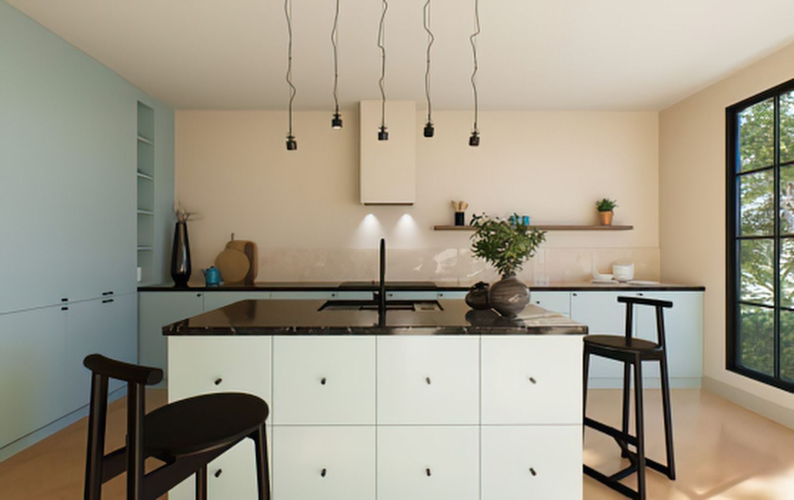 Modern kitchen with white island, black pendant lights, and large windows.