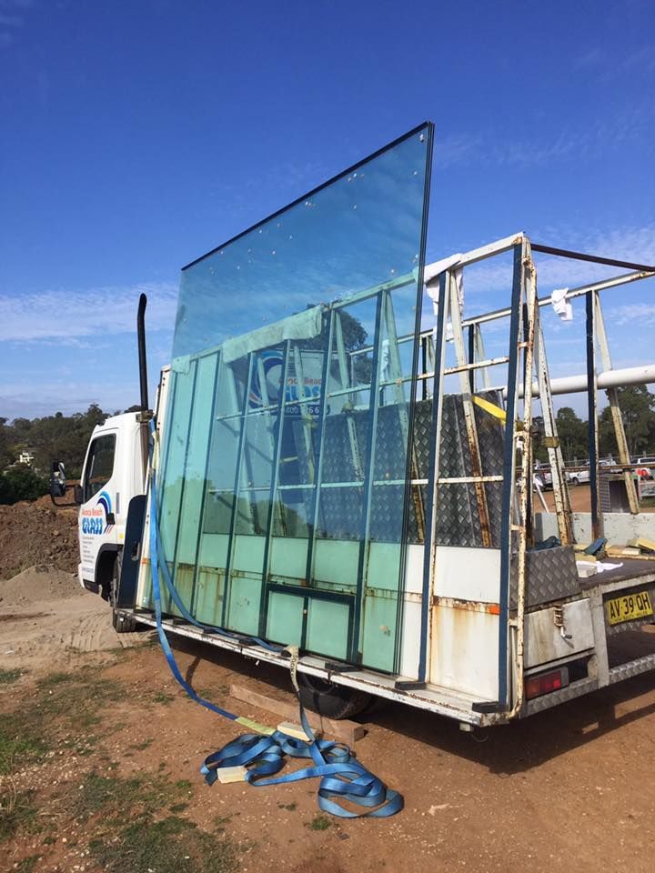 A Large Piece Of Glass Is Sitting On Top Of A Truck — Avoca Beach Glass In Kariong, NSW