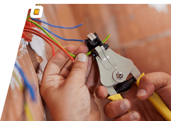 an electrical contractor cutting wires with cutting pliers