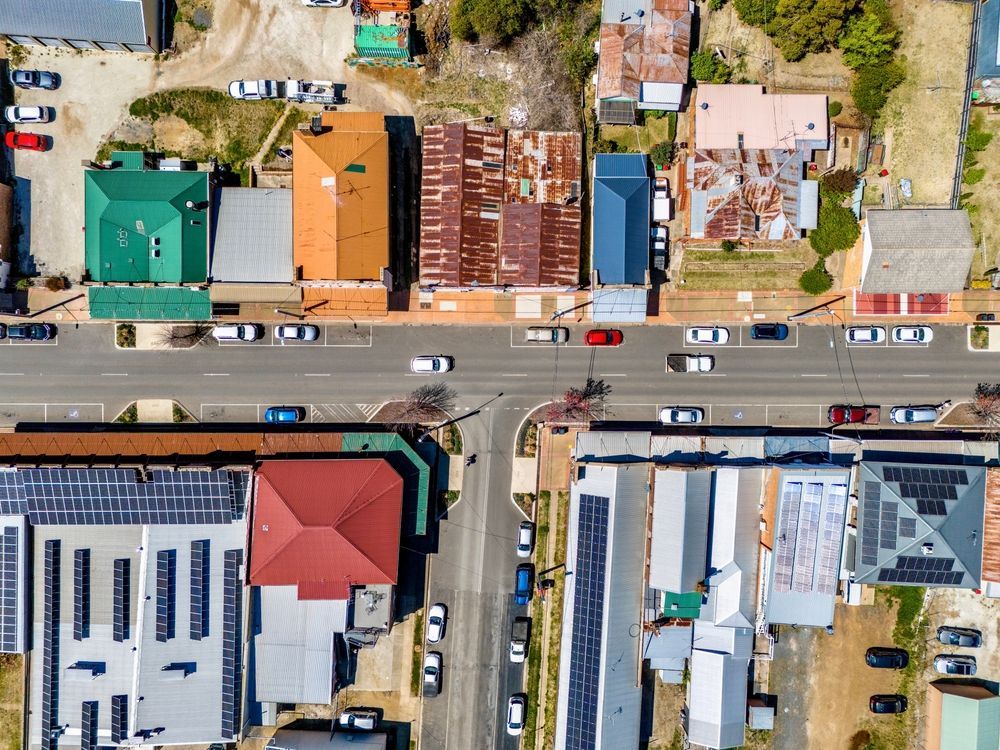 An Aerial View of a Residential Area With Lots of Buildings and Solar Panels on the Roofs — Nick Blackman Electrical Pty Ltd In Guyra, NSW