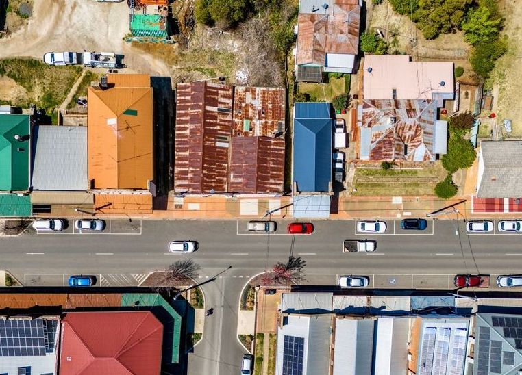 An Aerial View of a Residential Area With Lots of Buildings and Solar Panels on the Roofs — Nick Blackman Electrical Pty Ltd In Guyra, NSW