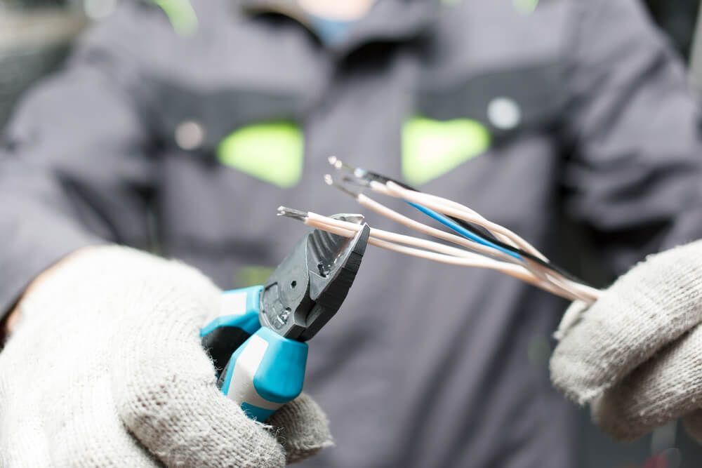 Electrician Stripping Wire Insulations — Electrical Services in Walcha, NSW