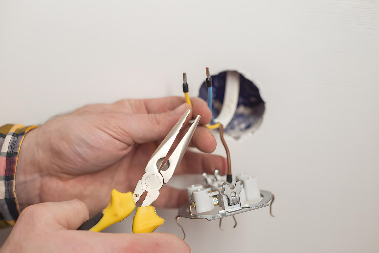 Electrician Peeling Off Insulation — Electrical Services in Armidale, NSW