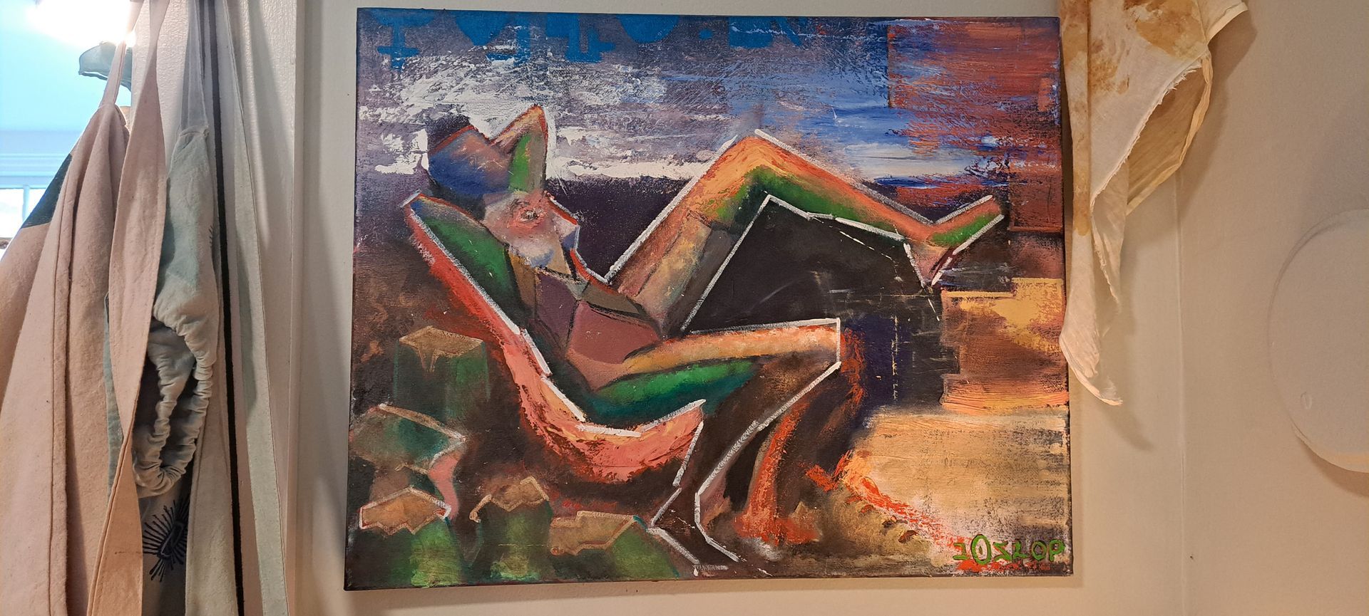 Abstract artwork of a person reclining, composed of geometric shapes in vibrant colors against a textured backdrop.