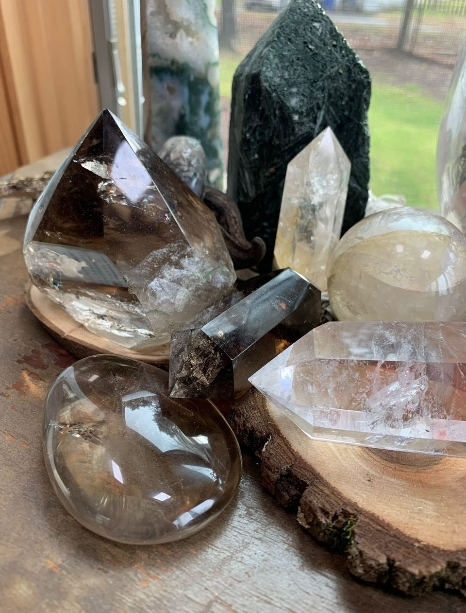 Collection of various quartz crystals in smoky gray and clear colors.