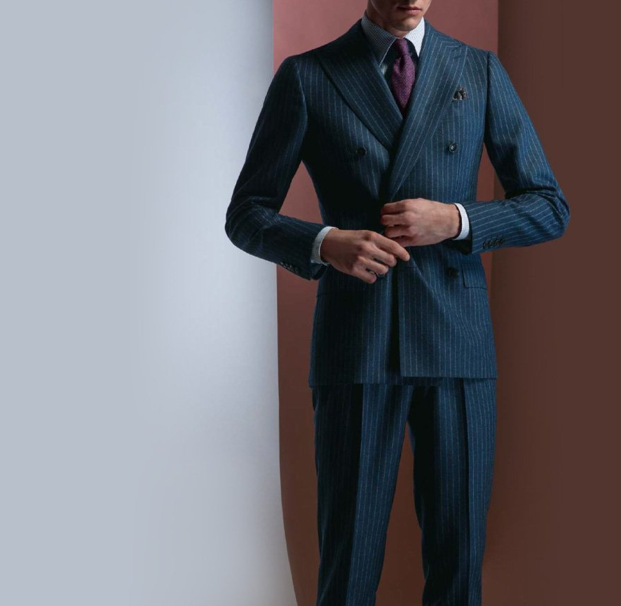 A man in a blue suit and purple tie