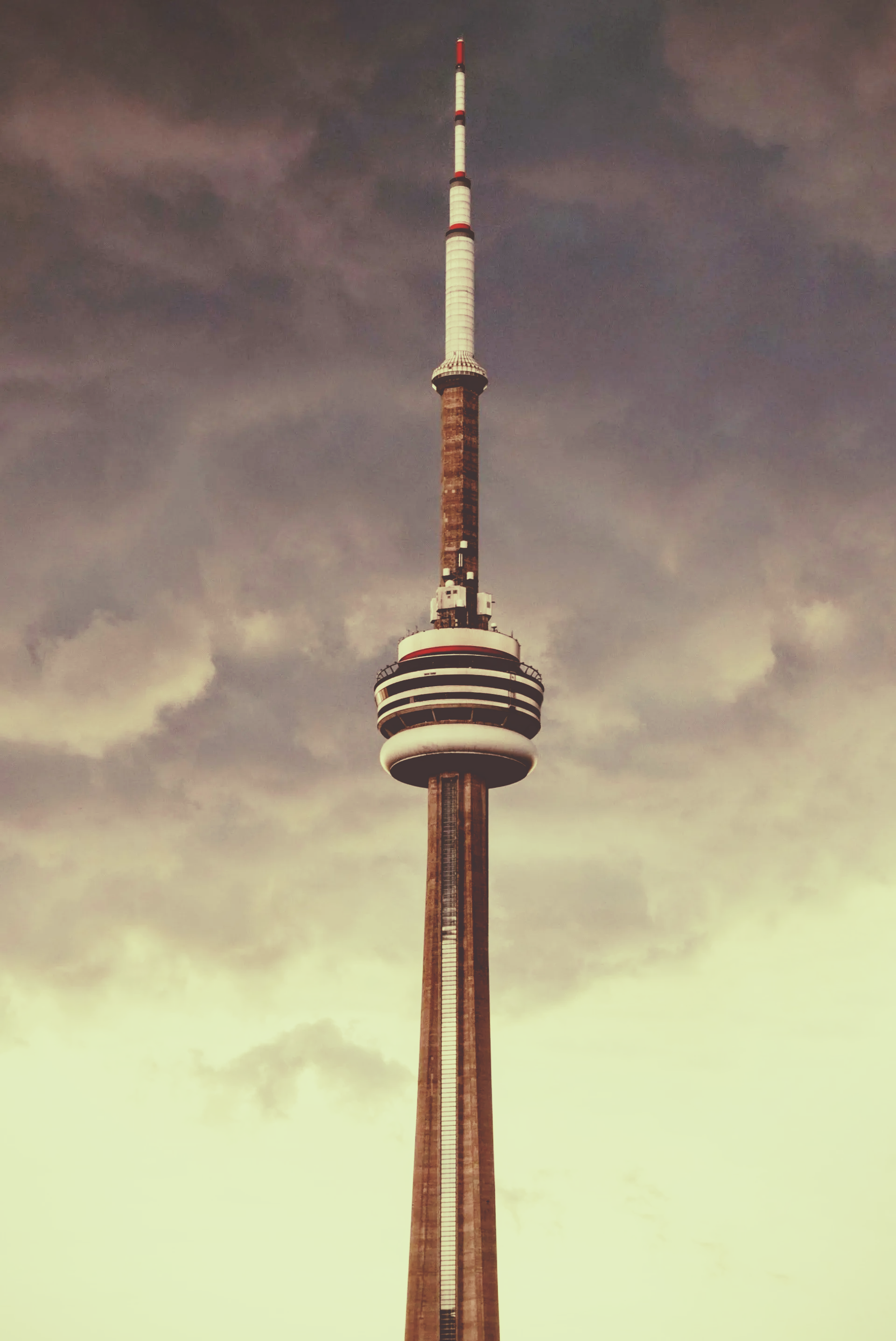A tall tower with a cloudy sky in the background