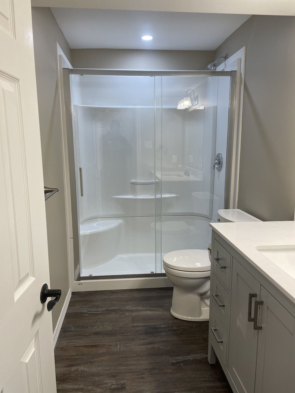 A bathroom with a toilet , sink , shower and tub.