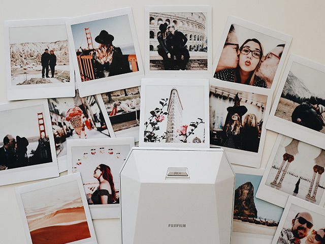 Vases with a plant in it next to pictures of people on the beach