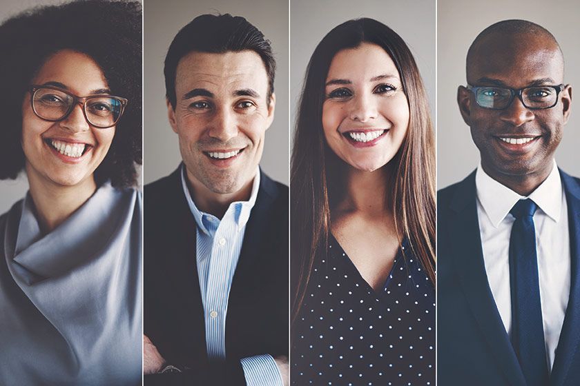 A group of people are smiling for the camera in a row.