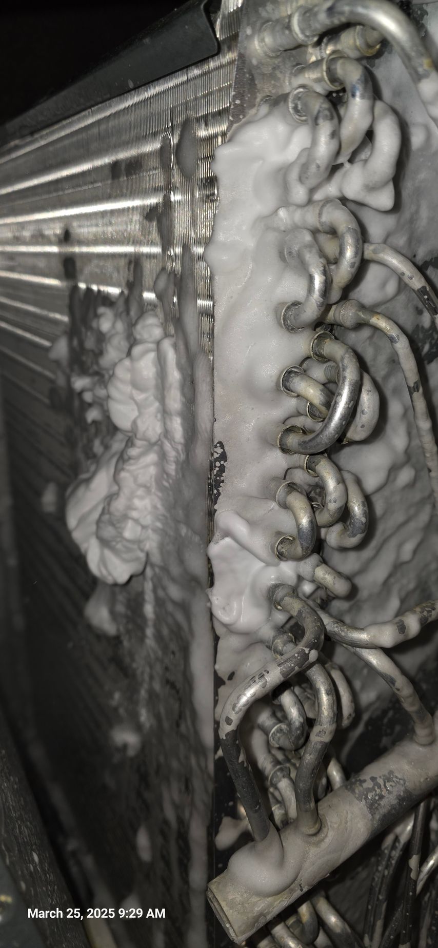 Coil cleaner foam covering the interior of an air conditioner unit.