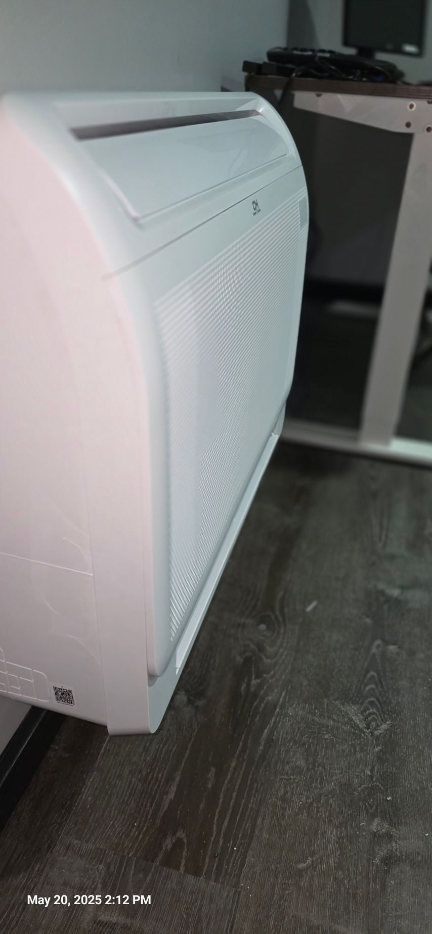 A white air conditioning unit is installed on a wall indoors.