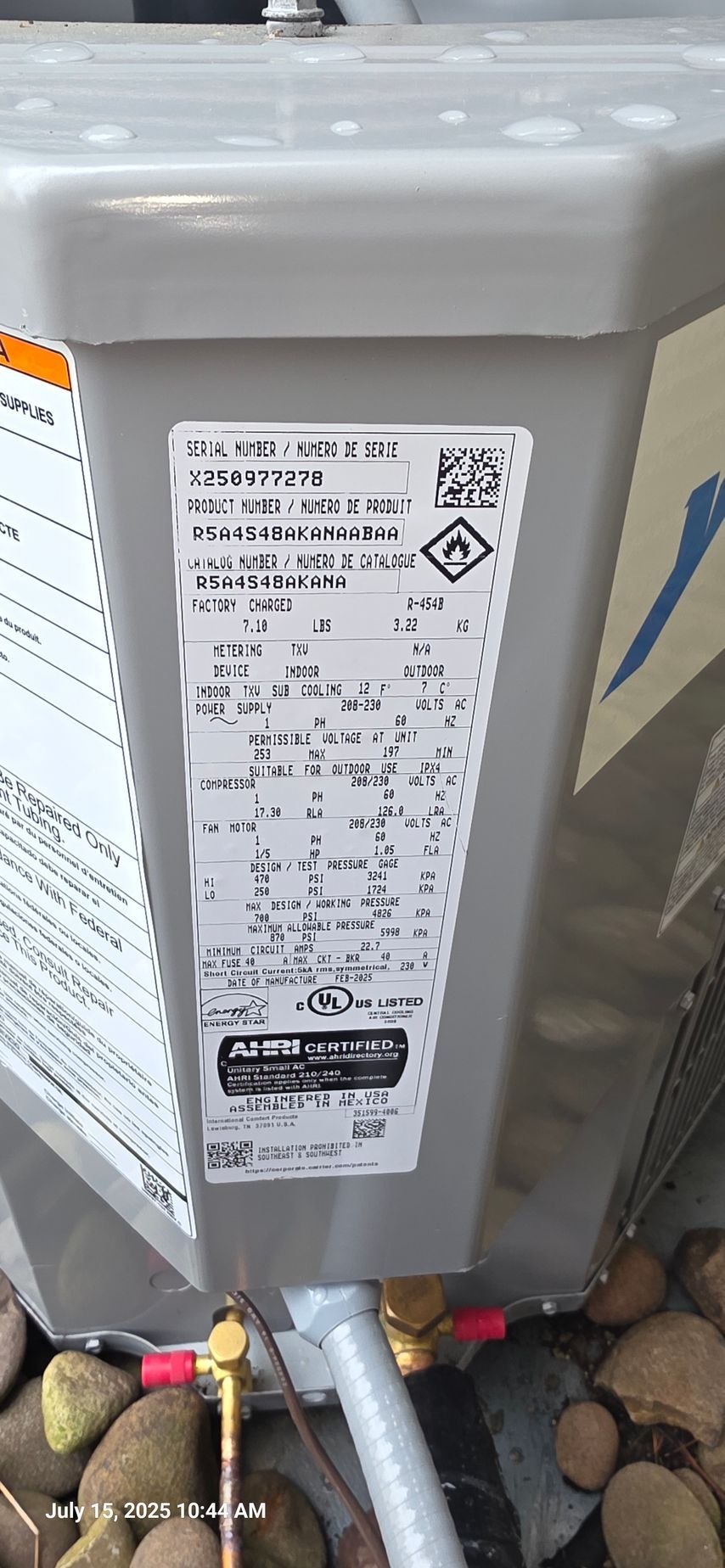 Air conditioning unit label with safety symbols and specifications.