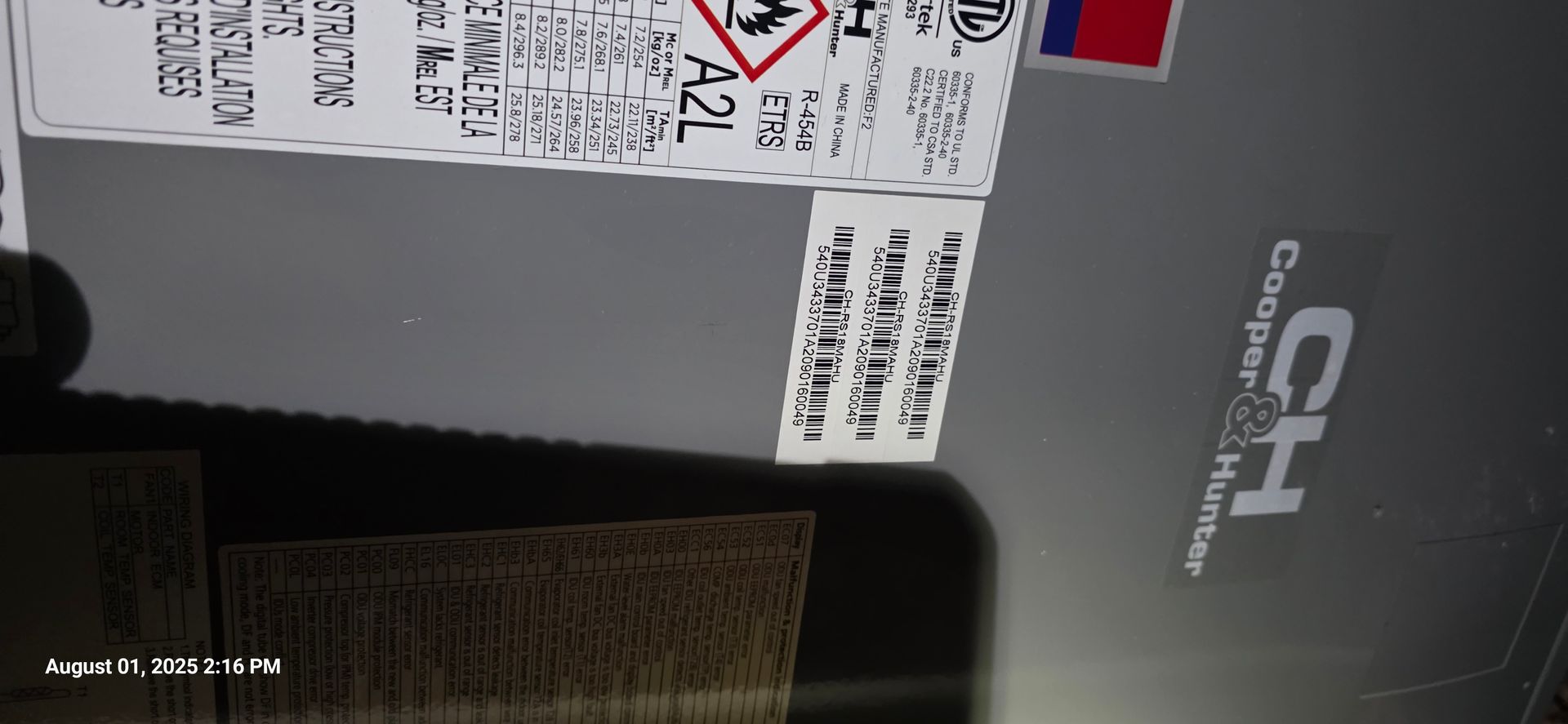 A close-up of a CH Coopear & Hunter product with labels, a partial view of a wooden surface, and a date stamp.