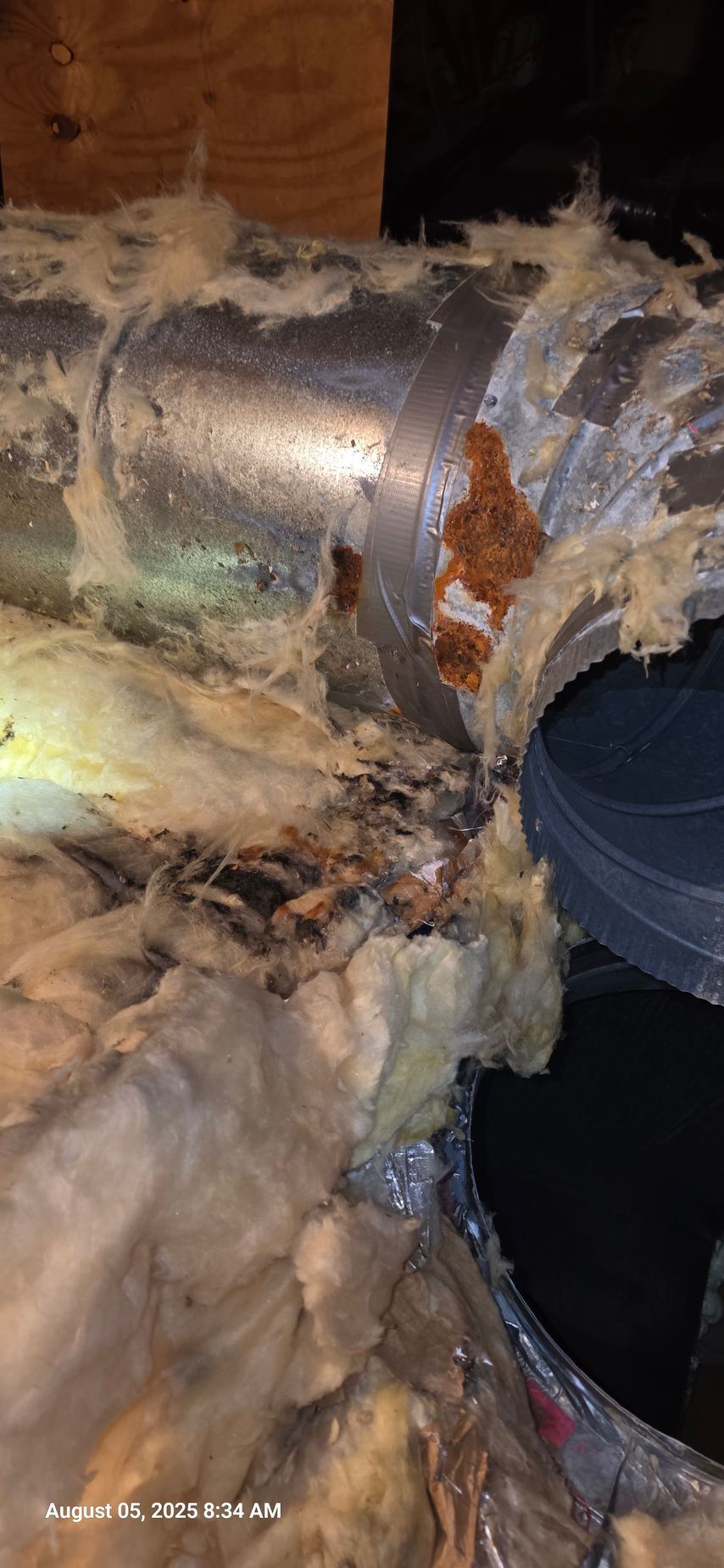 Ductwork with insulation and apparent water damage. Corrosion is visible.